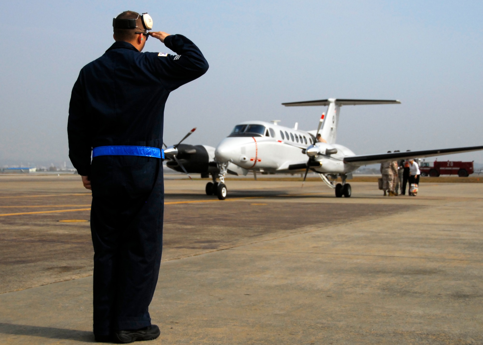 Senior Airman Theodore “Teddy” Murrill, 51st Maintenance Squadron transient alert and crash recovery team member, salutes a distinguished visitor’s aircraft on the flight line Nov. 8, 2011. The Transient Alert team is the first group of people the DVs see when visiting Osan AB. (U.S. Air Force photos/ 1st Lt. Sara Greco)