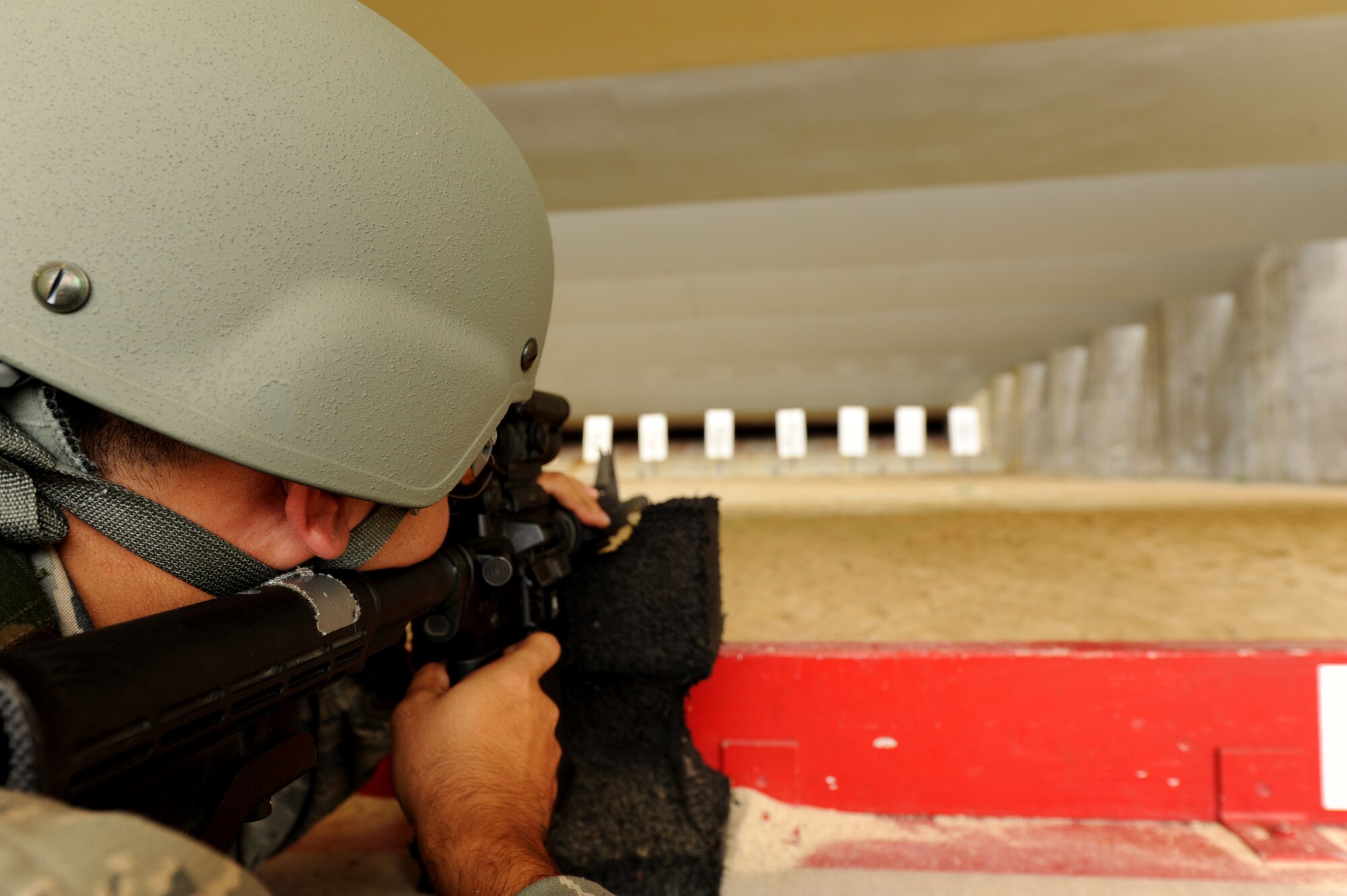 U.S. Air Force Staff Sgt. Michael Usher, 390th Intelligence Squadron linguist, fires an M-4 assault rifle during the new weapons qualifications course at Kadena Air Base, Japan, Nov. 8, 2011. Beginning Dec.1, all Airmen are required to perform in the modernized rifle qualification course which comprises movement while engaging targets to better train and equip Airmen for today's fight. (U.S. Air Force photo by Senior Airman Jarvie Z. Wallace/Released)    

