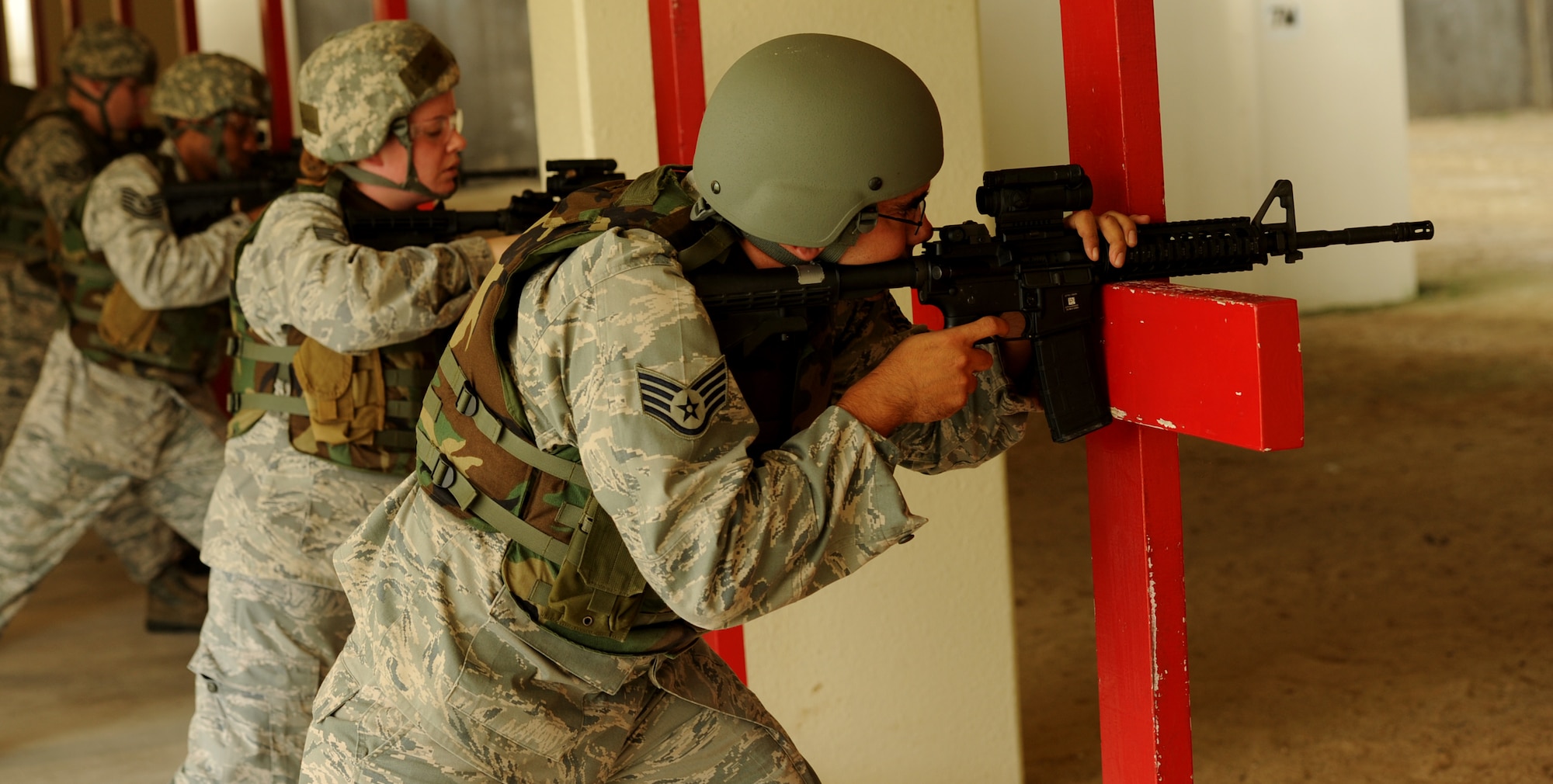 Kadena Airmen practice engaging threats during the new weapons qualifications course at Kadena Air Base, Japan, Nov. 8, 2011. Beginning Dec.1, all Airmen are required to perform in the modernized rifle qualification course which comprises movement while engaging targets to better train and equip Airmen for today's fight. (U.S. Air Force photo by Senior Airman Jarvie Z. Wallace/Released)  

