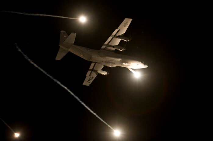 A U.S. Air Force C-130 Hercules performs evasive countermeasures by launching flares during a Mobility Air Forces Exercise Nov. 16, over the Nevada Test and Training Range. The U.S. Air Force Weapons School holds MAFEX twice a year to test the ability of C-17A Globemaster III and C-130 Hercules aircrews from Air Force bases around the world to join together in a formation at a specific time and location to insert ground forces anywhere in the world. The 820th RED HORSE Airborne Flight conducted airdrops over the NTTR. (U.S. Air Force photo by Senior Airman Brett Clashman/Released)