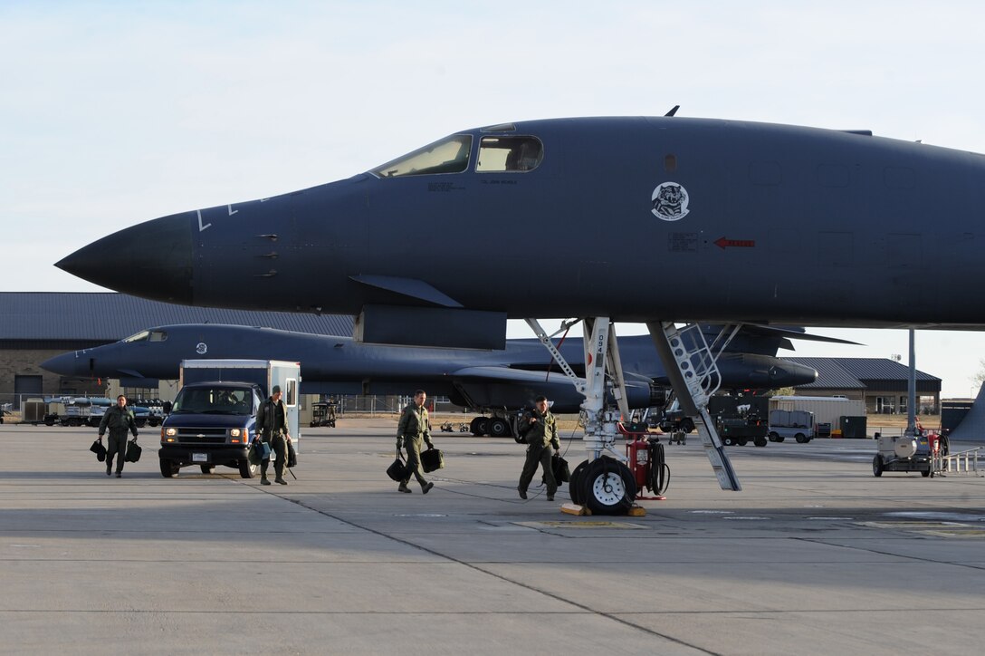 A B-1B Lancer crew steps out to their aircraft prior to flight during surge operations at Ellsworth Air Force Base, S.D., Nov. 17, 2011. The training opportunity tested the combat readiness and effectiveness of the B-1B Lancer, which can carry the largest payload of both guided and unguided weapons of all aircraft in the Air Force inventory. (U.S. Air Force photo by Senior Airman Kasey Close/Released)