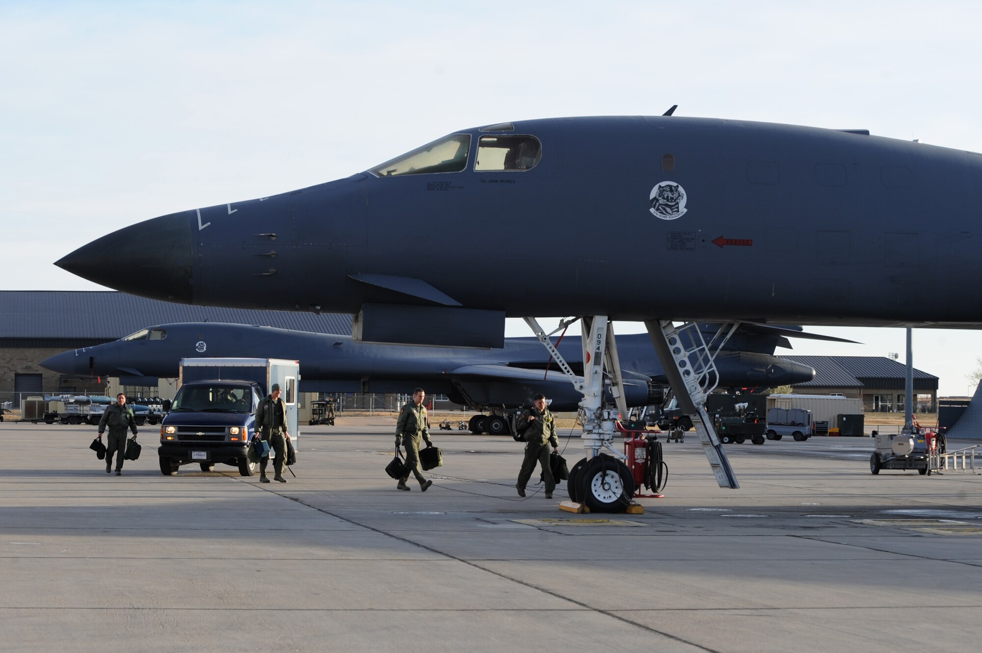 A B-1B Lancer crew steps out to their aircraft prior to flight during surge operations at Ellsworth Air Force Base, S.D., Nov. 17, 2011. The training opportunity tested the combat readiness and effectiveness of the B-1B Lancer, which can carry the largest payload of both guided and unguided weapons of all aircraft in the Air Force inventory. (U.S. Air Force photo by Senior Airman Kasey Close/Released)