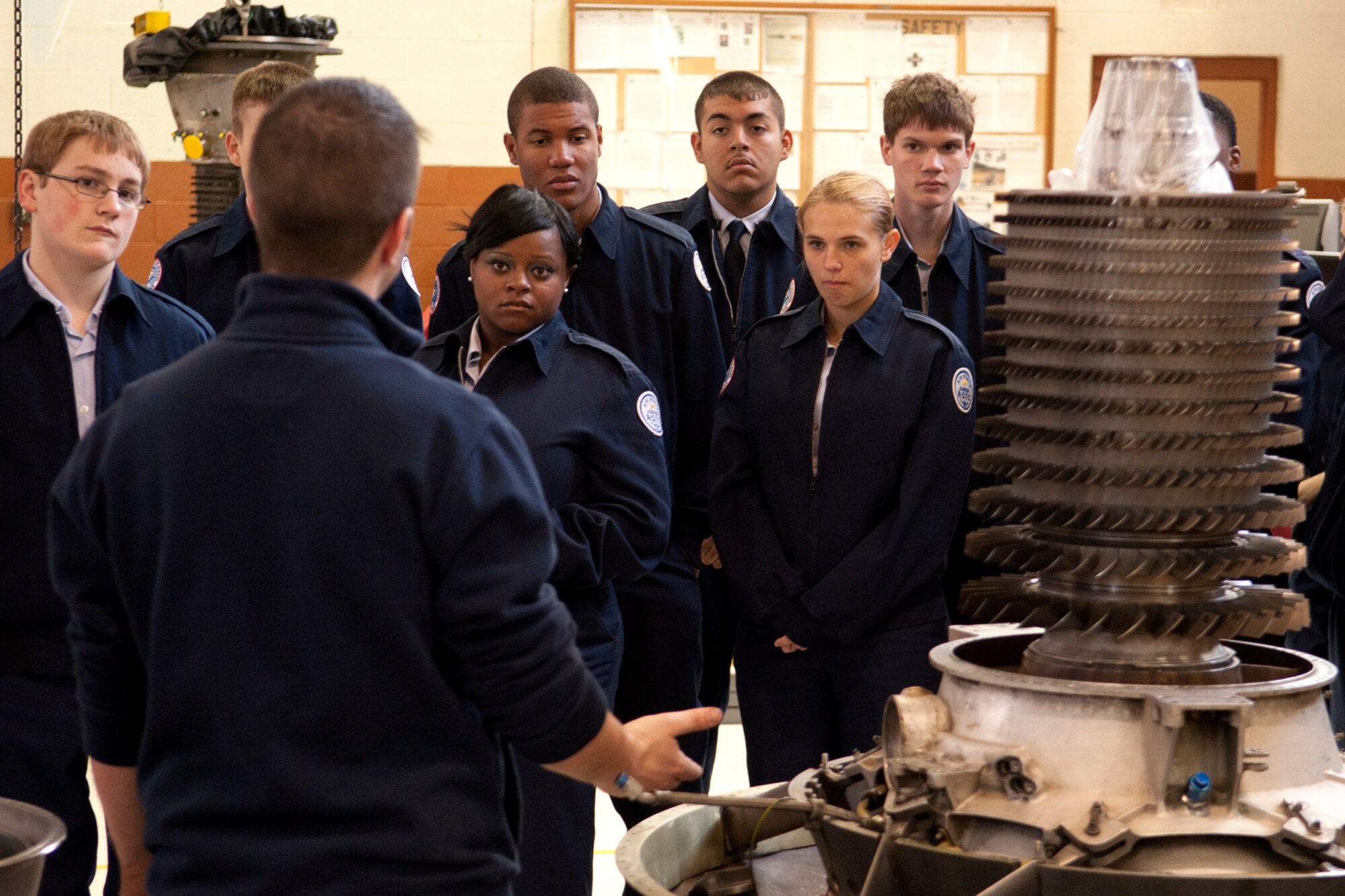 Cadets from the Marshall High School Junior Reserve Officers' Training Corps look on as U.S. Air Force Staff Sgt. Beau Traweek, 917th Maintenance Squadron jet engine mechanic, talks about the disassembly and inspection of an engine for the A-10 Thunderbolt II. The cadets visited Barksdale and were given a tour of an A-10 and the 917th Operations Support Squadron aircrew flight equipment shop. (U.S. Air Force photo by Master Sgt. Greg Steele/Released)