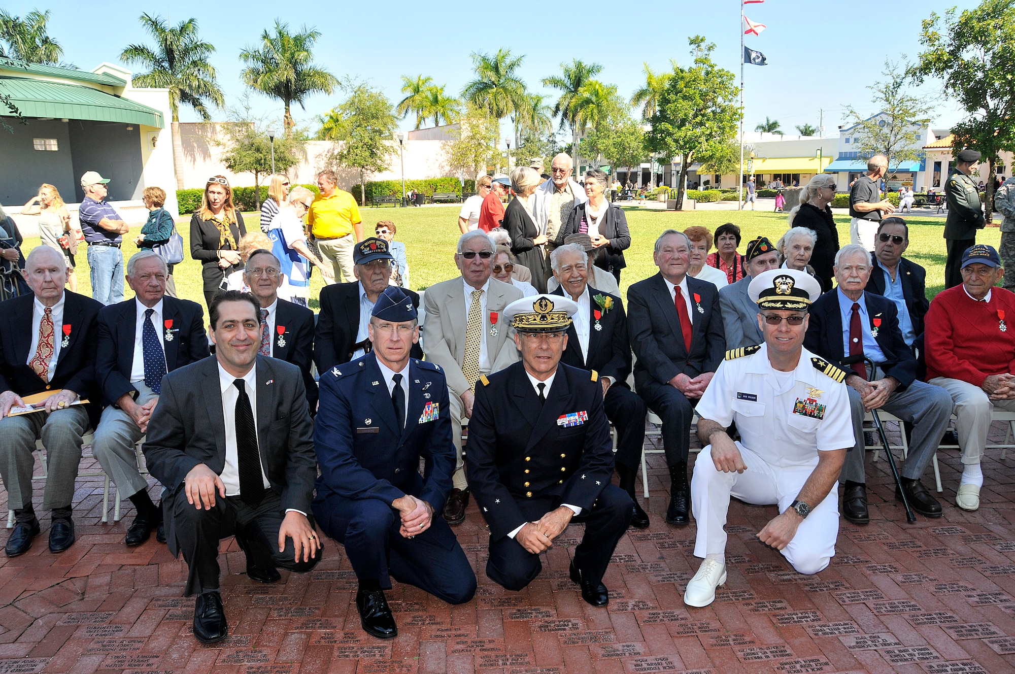 Ten American veterans (seated), who fought alongside French forces during World War II were awarded the insignia of Chevalier dans l'Ordre National de la Legion d'Honneur, or Knight in the National Order of the Legion of Honor, in a ceremony at Losner Park on Veteran's Day, Nov. 11. From left, French Consul General, Mr. Gael de Maisonneuve; Col. Donald R. Lindberg, Commander, 482nd Fighter Wing; France Rear Admiral Patrick J. Martin, U.S. Central Command; and Navy Capt. Robert Wilson, Deputy Commander, Special Operations Command South took part in the ceremony. (U.S. Air Force photo/Tim Norton)