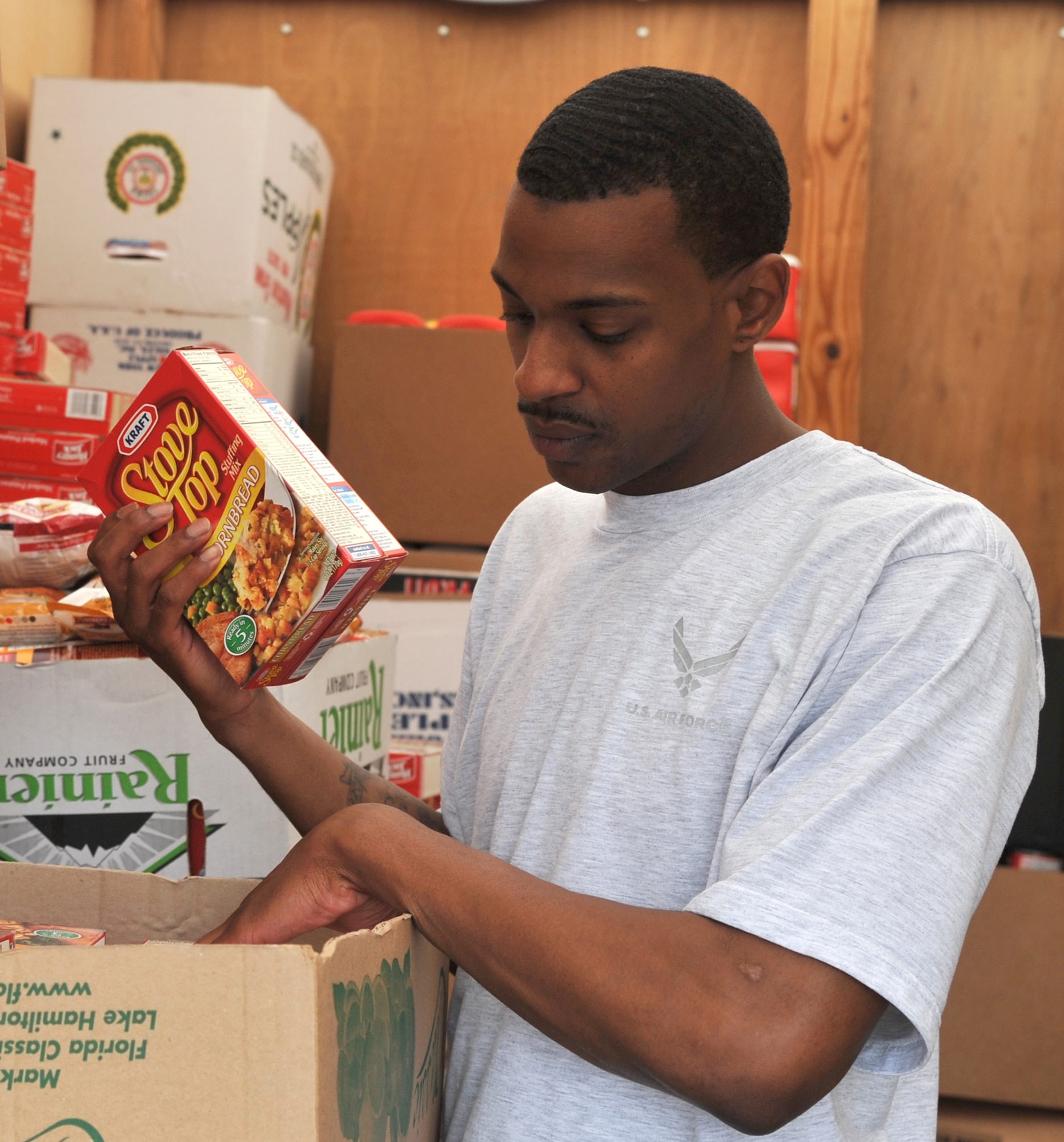 U.S. Air Force Staff Sgt. Daniell Branch, 633rd Logistics Readiness Squadron equipment technician, sorts food donations for Operation Warmheart at Langley Air Force Base, Va., Nov. 15, 2011. Donations are distributed to families during the holiday season, primarily Thanksgiving and Christmas; first sergeants coordinate with supervisors to identify Airmen that would benefit most from the baskets. (U.S. Air Force photo by Airman 1st Class Camilla Griffin/Released)