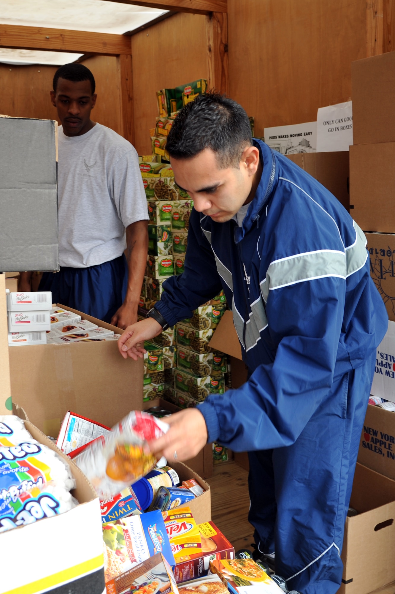 U.S. Air Force Staff Sgts. Daniell Branch and Andres Olivia, 633rd Logistics Readiness Squadron equipment technicians, organize food donations for Operation Warmheart at Langley Air Force Base, Va., Nov. 15, 2011. In 2010 the First Sergeants Council delivered 505 baskets for Thanksgiving; the council’s goal is to distribute 500 baskets annually. (U.S. Air Force photo by Airman 1st Class Camilla Griffin/Released)