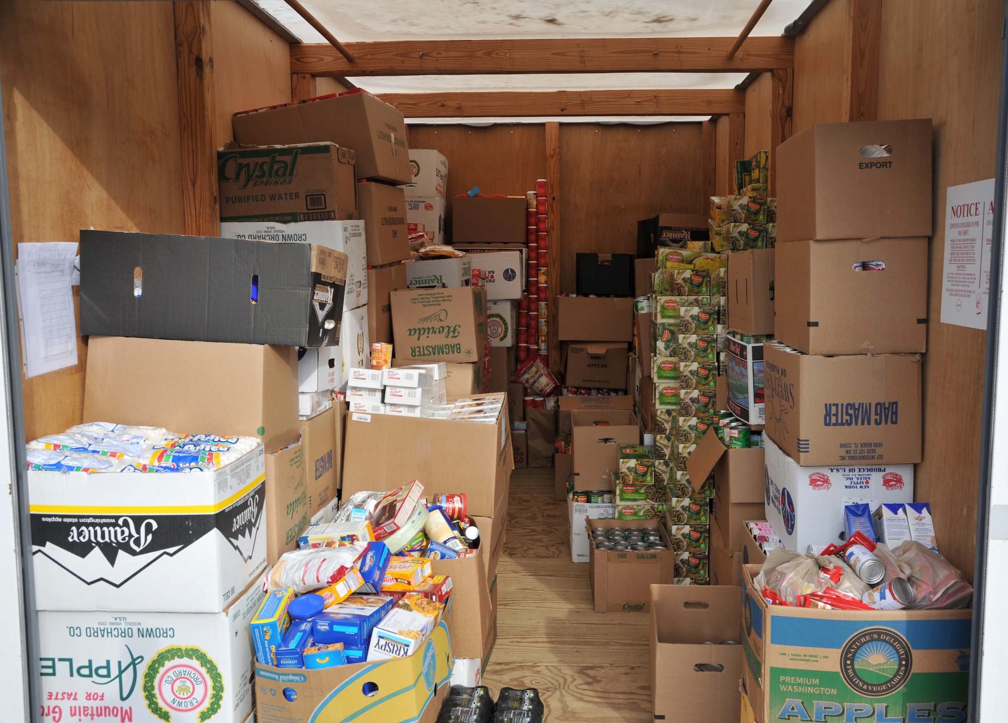 Operation Warmheart donations are stored in large containers at Langley Air force Base, Va., Nov. 15. More than 300 volunteers from across the installation dedicated time to collecting food, organizing and packing baskets, and delivering the bundles to families. (U.S. Air Force photo by Airman 1st Class Camilla Griffin/Released)