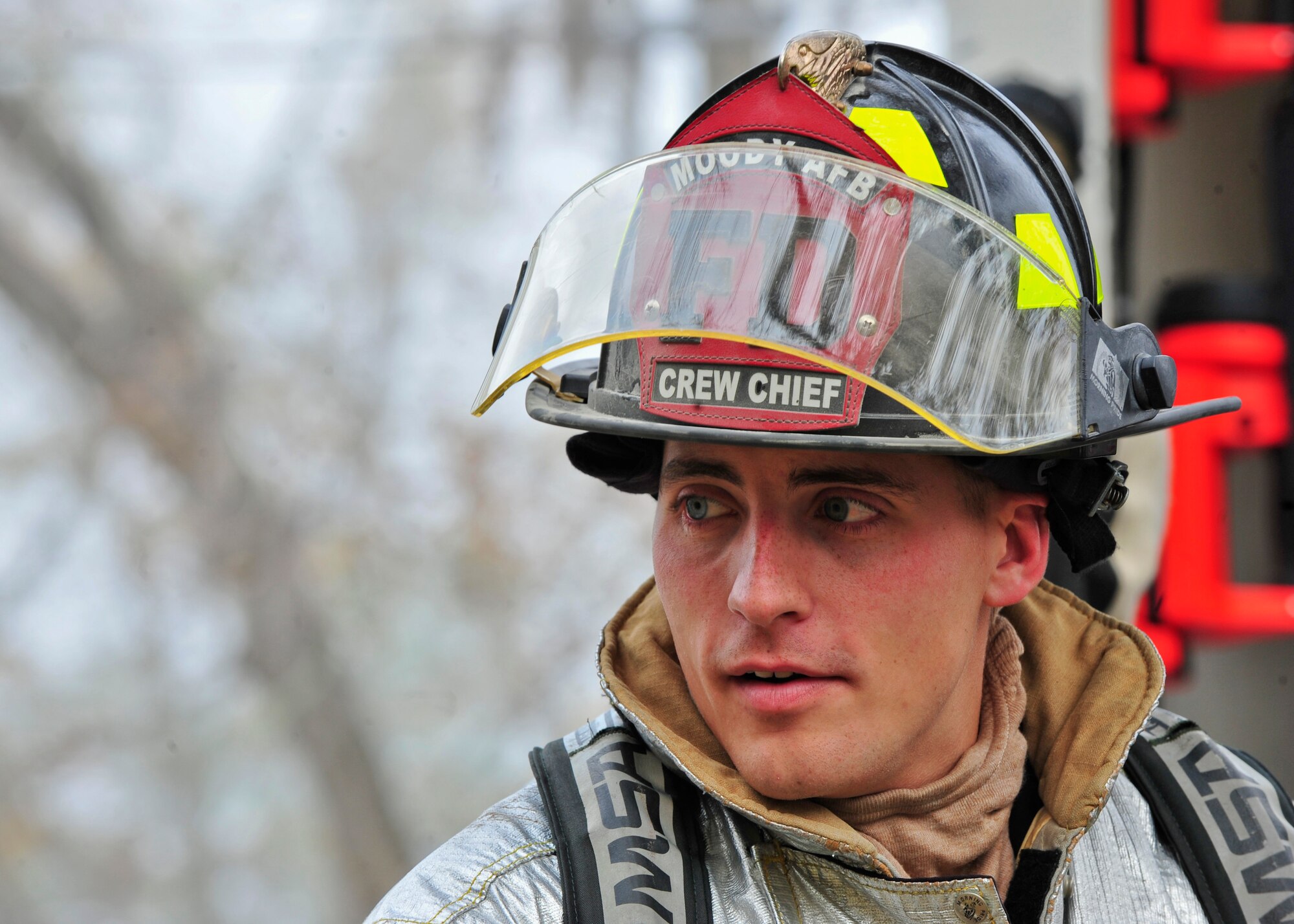 U.S. Air Force Staff Sgt. William Strauss, 23rd Civil Engineer Squadron crew chief firefighter looks back at his fellow firefighter before heading into a house fire during live-fire training with the Valdosta Fire Department in Valdosta, Ga., Nov. 15, 2011. The Valdosta and 23rd CES firefighters trained together to familiarize on each other’s procedures in the event they fight a fire together. (U.S. Air Force photo by Staff Sgt. Stephanie Mancha/Released)