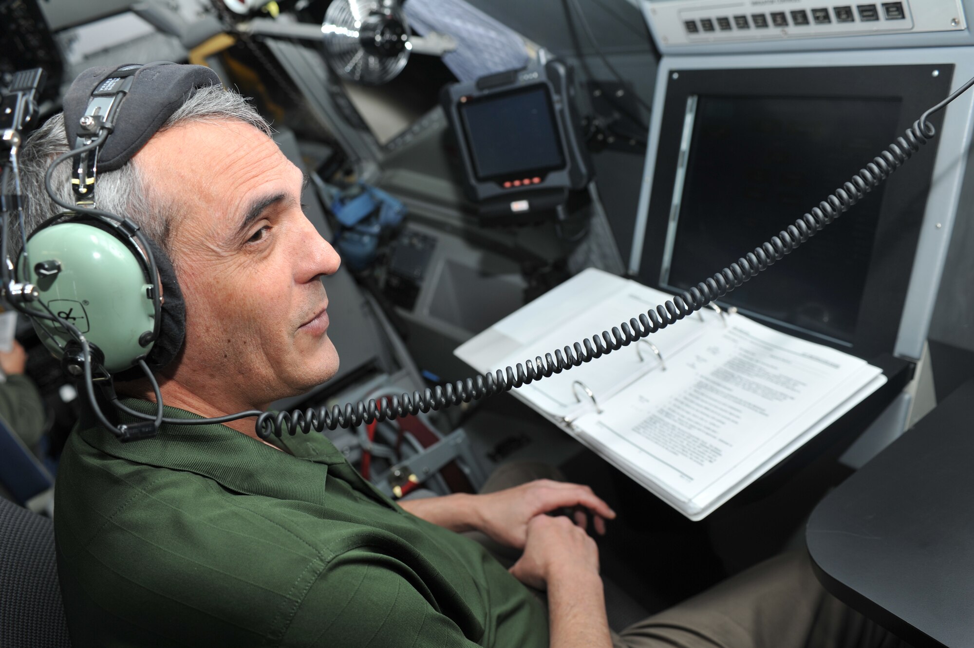 Mr. Chris Harper, 92nd Operations Support Squadron, pilot instructor observes KC-135 pilots while they are training in the KC-135 Aircrew Training System Nov. 10. (U.S. Air Force photo/ Airman 1st Class Tyirez Frost)