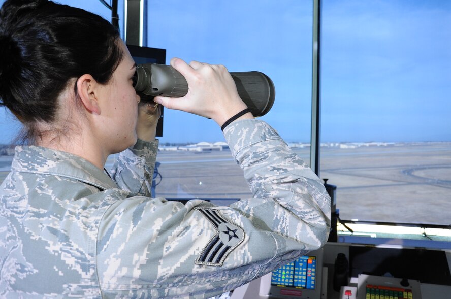 Senior Airman Ashley Mangiaracina, 92nd Operations Support Squadron, air traffic controller, looked down the runway using binoculars checking for animal activity Nov. 10. The Air Traffic Controllers monitor animal activity on the runway, and they also check to see if the landing gear is down on the aircraft as it lands.  (U.S. Air Force photo/Senior Airman Jordan Pollock)