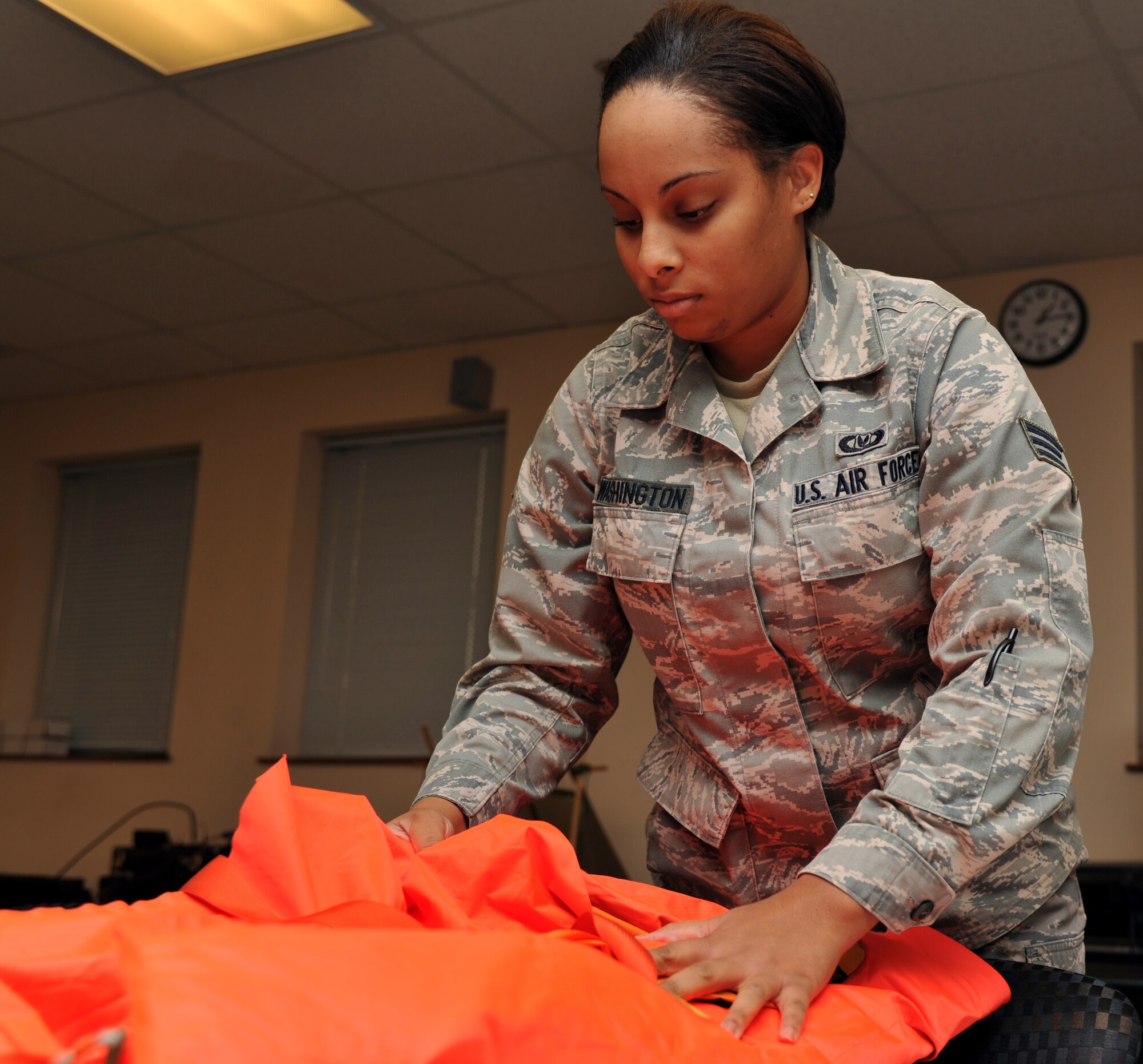 Senior Airman Maryam Washington, 92nd Operations Support Squadron, airfield flight equipment journeyman inspects a 6-P infant cot Nov. 10. Before each KC-135 flight, the airfield flight equipment team inspects the life support equipment on the aircraft.  The flight also maintains all aircrew life support equipment in storage for the aircrew. (U.S. Air Force photo/Senior Airman Jordan Pollock)
