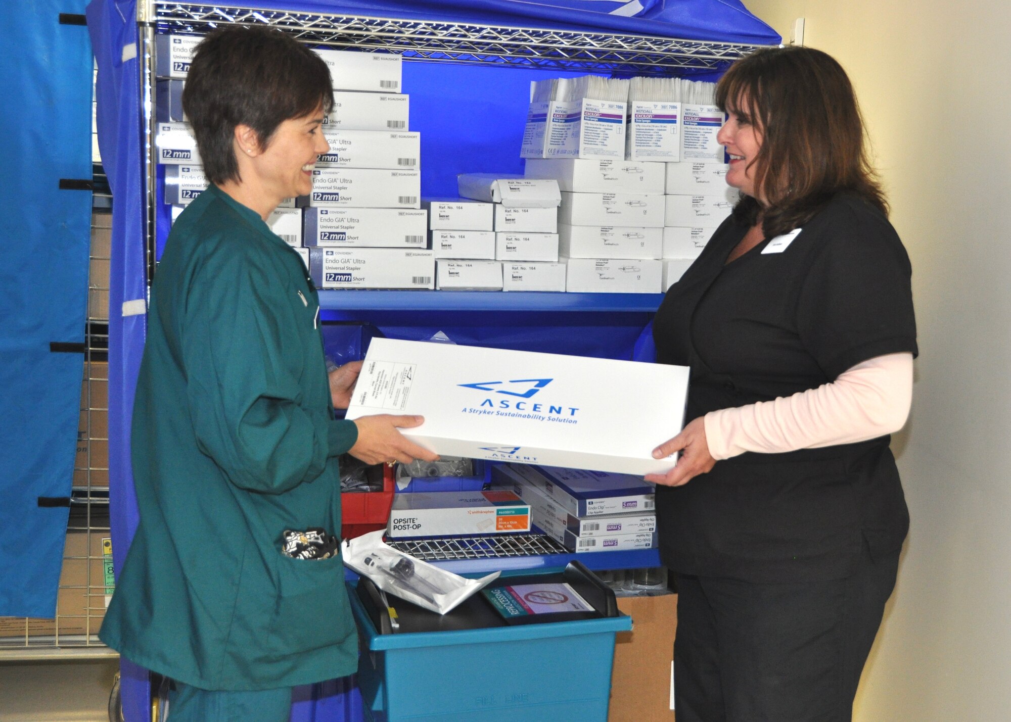 KEESLER AIR FORCE BASE, Miss. -- Joan Sullivan, account manager for Stryker/Ascent Sustainability, passes Capt. Wendy Wilkins, an 81st Surgical Operations Squadron operating room nurse, a remanufactured harmonic scalpel used for laparoscopic procedures. The container between them is one of the reprocessing bins located in each
operating room. (U.S. Air Force photo/Steve Pivnick)
