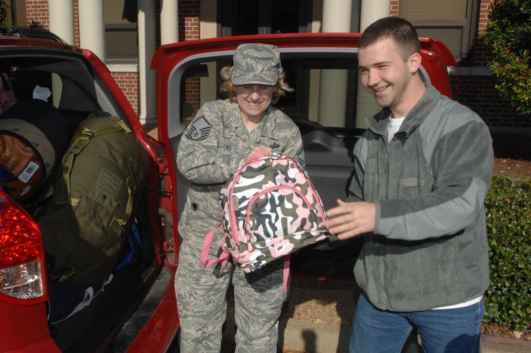 Master Sgt. RobynAnn Iulliano, Creech Conference Center superintendant, and Airman 1st Class Benjamin Spiegel, 30th Intelligence squadron analyst, collect donations for the 2nd Annual Used Coat and Survival Backpack Drive at Langley Air Force Base, Va., Nov. 18, 2011. More than 300 coats and 100 backpacks were collected and distributed to various organizations, such as H.E.L.P. Inc and The Break Through Center. (U.S. Air Force photo by Staff Sgt. Jeffrey Nevison/Released)