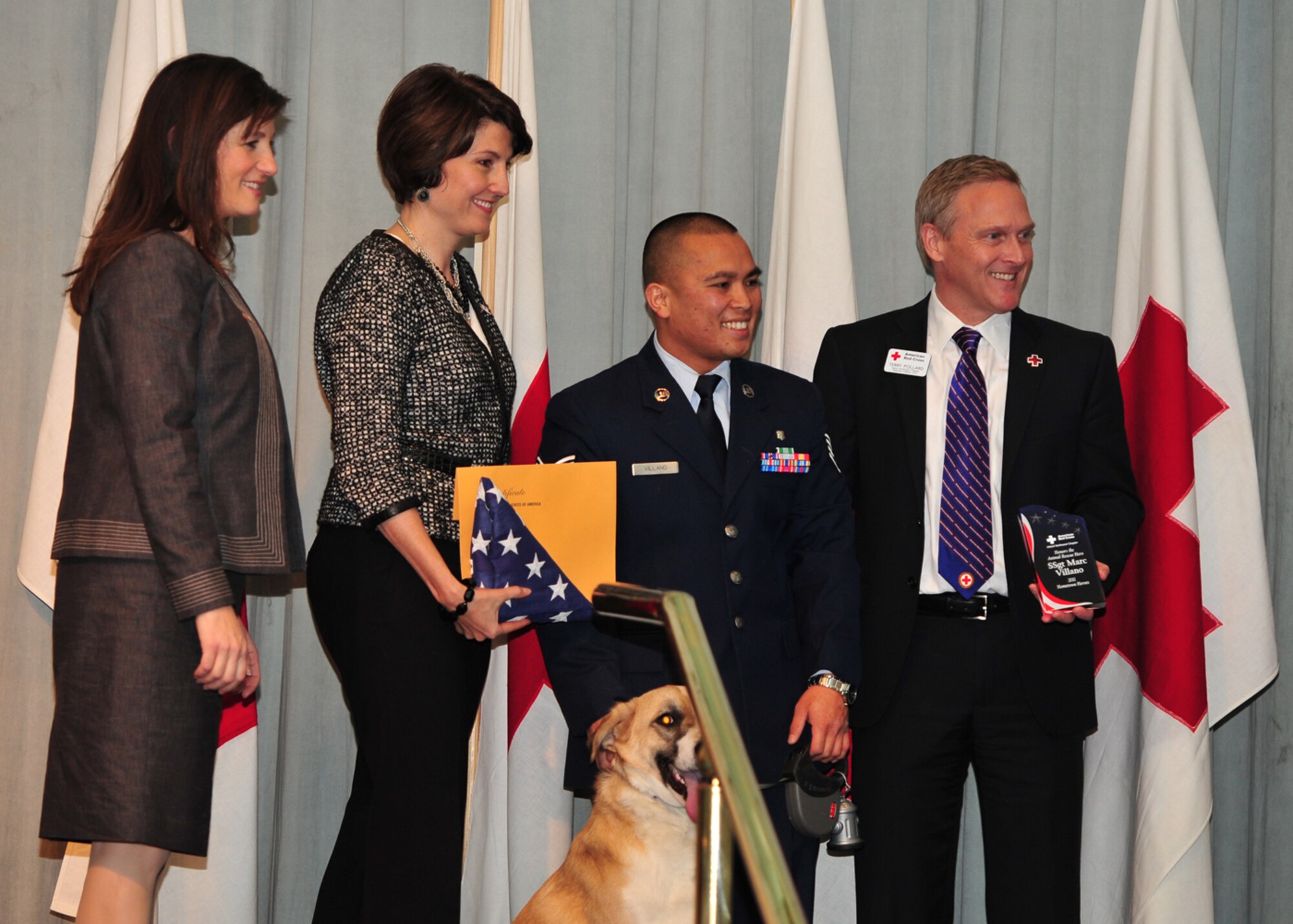 Staff Sgt. Marc Villano, 92nd Medical Operations Squadron, and his dog Trever were given the 2011 Animal Rescue Heroes Award Nov. 10. Villano was given this award for his actions in Afghanistan. Villano found a 3-week-old puppy when he and his team were involved in a typical mission in the local community. Trever helped comfort soldiers  in Aghanistan. (U.S. Air Force photo/Staff Sgt. Michael Means)