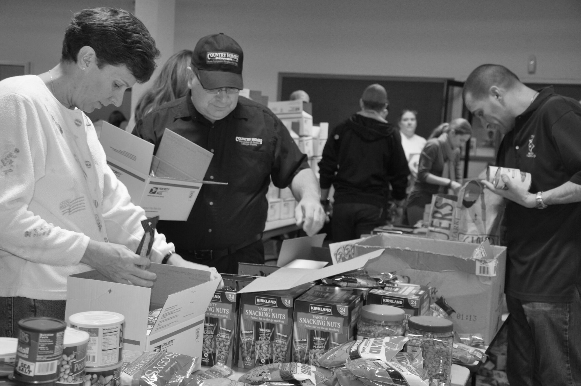 Members of Fairchild’s enlisted and officers’ spouses clubs, the first sergeants council, volunteer Airmen and even volunteers from Country Home Power came together to assemble care packages for deployed Fairchild Airmen at the Deel Community Center Nov. 11. The community donated items through KREM’s Treats 2 Troops drive. (U.S. Air Force photo/Tech. Sgt. Jennifer Buzanowski)