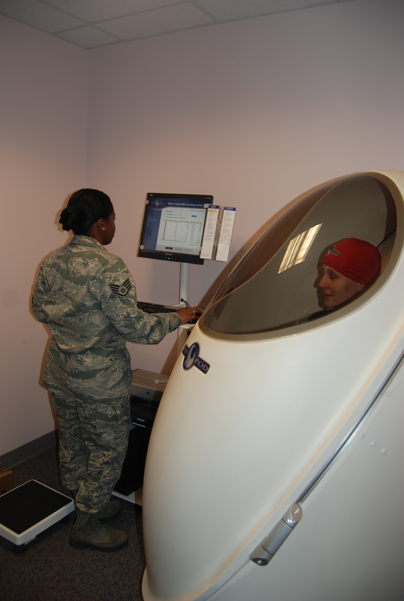 Staff Sgt. Ronneisha Sargent, Health and Wellness Center noncommissioned officer in charge, monitors the information from the BOD POD body composition test. The body composition test takes about two minutes to complete and calculates an individual’s body density and body fat. The BOD POD is one of three new pieces of testing equipment the HAWC has available free of charge. (U.S. Air Force photo/Lea Johnson)