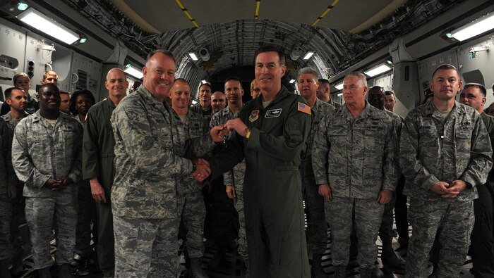 Brig. Gen. Steven Arquiette presents the keys to Joint Base Charleston's newest C-17 Globemaster III to Col. Erik Hansen at Joint Base Charleston Air Base Nov. 9. Arquiette is the Headquarters Air Mobility Command, Scott Air Force Base inspector general  and Hansen is the 437th Airlift Wing commander. (U.S. Air Force photo/Airman 1st Class Ashlee Galloway)