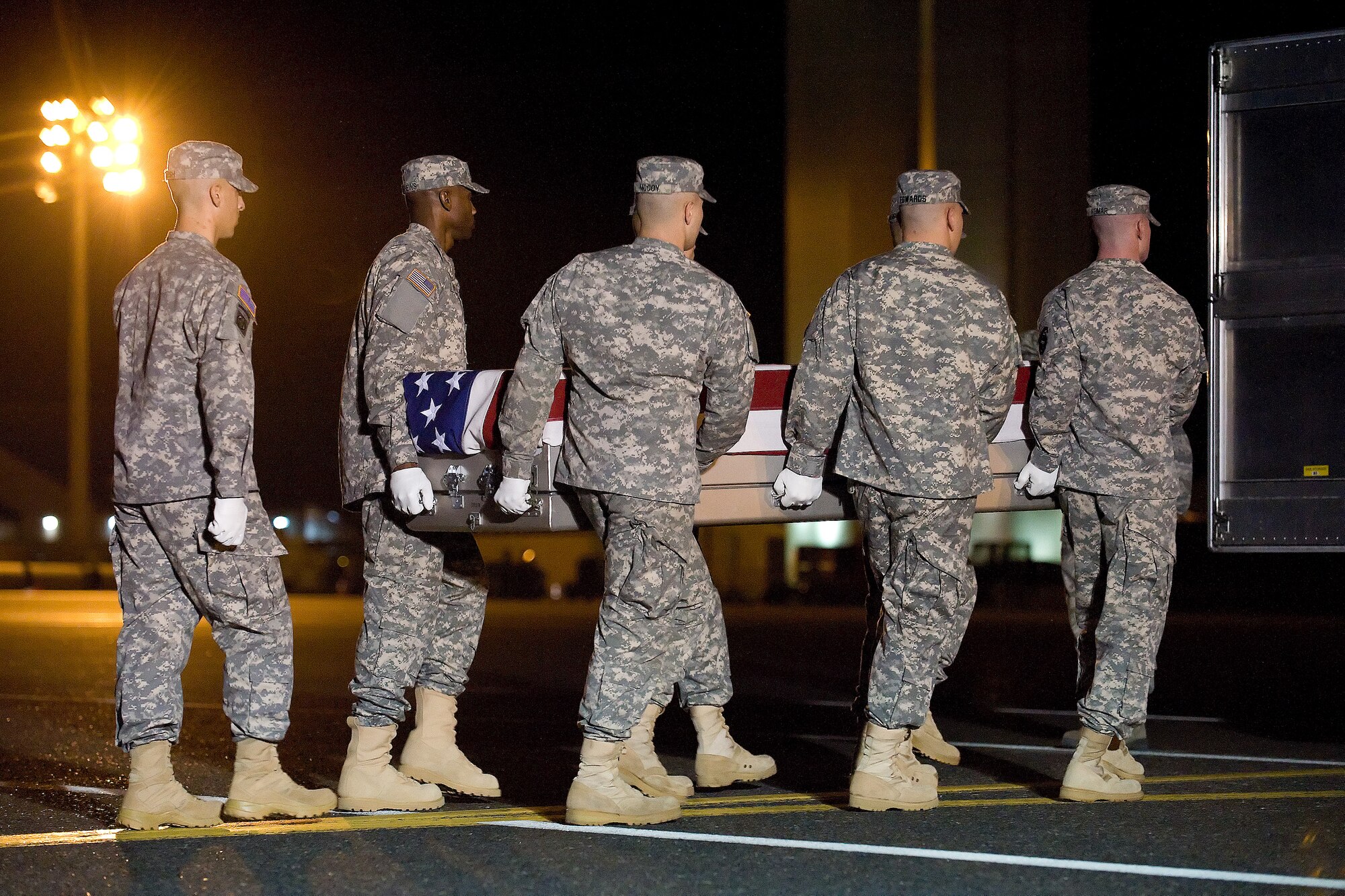 A U.S. Army carry team transfers the remains of Army Pfc. Adam E. Dobereiner or Moline, Ill., at Dover Air Force Base, Del., Nov. 20, 2011. Dobereiner was assigned to the 8th Engineer Battalion, 36th Engineer Brigade, Fort Hood, Texas. (U.S. Air Force photo/Adrian R. Rowan)