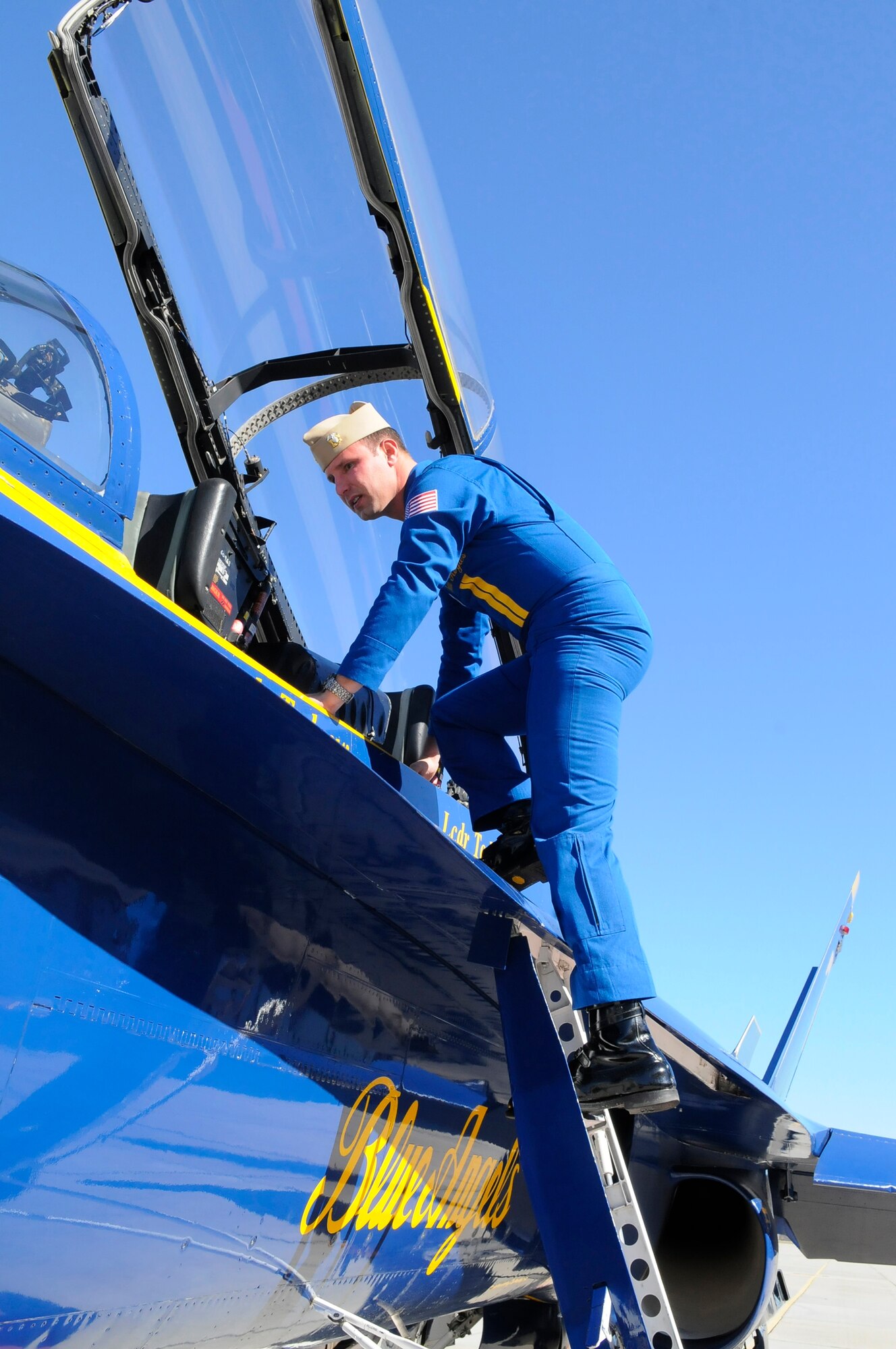 Lt. Cmdr. Todd Royles, Blue Angel event coordinator, climbs out of the #7 aircraft after landing at Robins for briefings and a tour of Robins facilities. The visit was for preparation for the April air show here. (U. S. Air Force photo by Sue Sapp)
