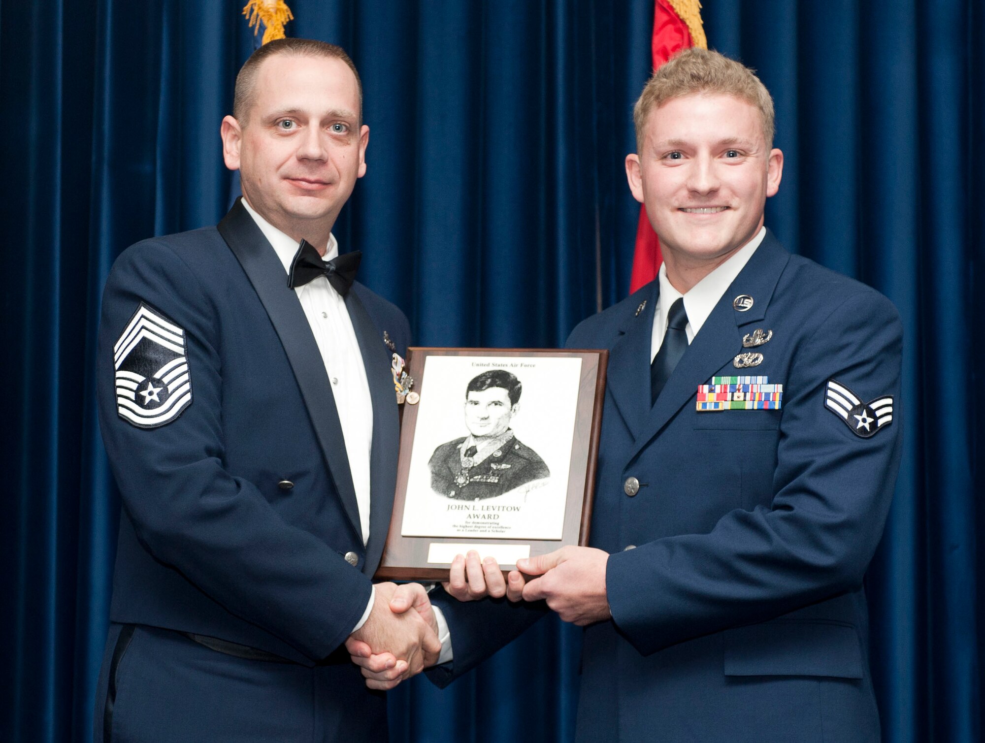 Senior Airman Alexander Blair, 39th Civil Engineer Squadron, right, receives the John L. Levitow award from Chief Master Sgt. Allen Markle, 39th Security Forces Squadron, during the Class 12-2 Incirlik Airman Leadership School graduation Nov. 18, 2011, at Incirlik Air Base, Turkey. The Levitow Award is the highest achievement for enlisted Airmen enrolled in U.S. Air Force professional military education. There are four levels of PME: ALS, NCO academy, Air Force Senior NCO Academy and Chief Master Sergeant Leadership Course. (U.S. Air Force photo by Senior Airman Clayton Lenhardt/Released)