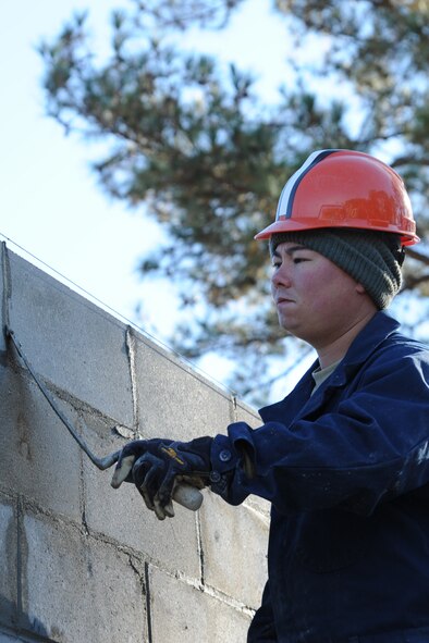 Staff Sgt. Kenneth Laswell uses a block trowel during a structural project on Seymour Johnson Air Force Base, N.C., Nov. 18, 2011. A block trowel is used in brickwork or stonework for leveling, spreading and shaping concrete. Laswell is a 4th Civil Engineer Squadron structural craftsman and a native of Corinth, Miss. (U.S. Air Force photo by Senior Airman Whitney Stanfield)