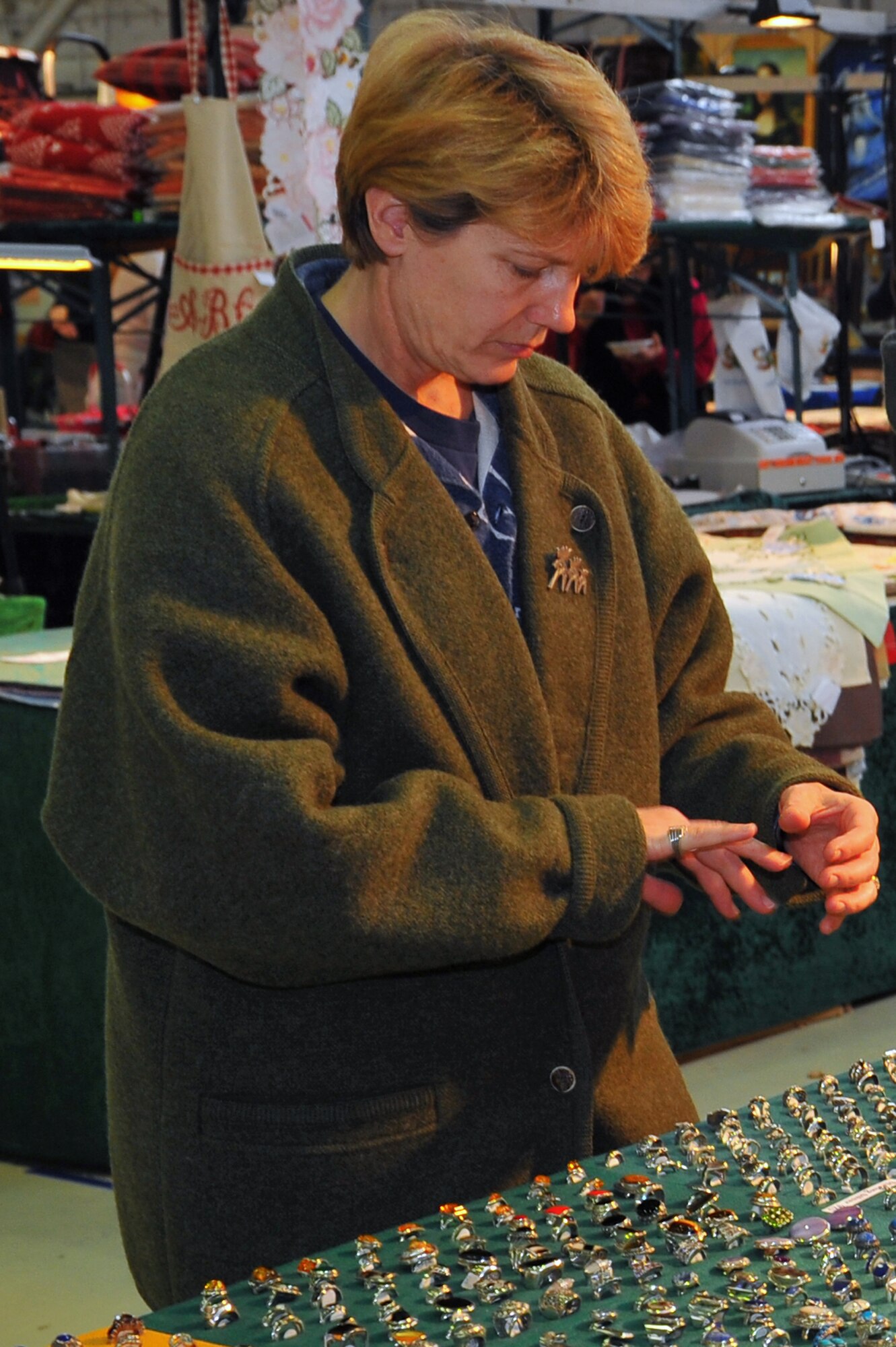 SPANGDAHLEM AIR BASE, Germany – Senior Master Sgt. Valerie Weaver, 52nd Fighter Wing Public Affairs superintendent, tries on a ring at the fall bazaar here Nov. 18. The Officer and Civilian Spouses Club hosts the bazaar annually, allowing vendors from across Europe to share their products with military members and their families. These products included foodstuffs, furniture and traditional German décor. (U.S. Air Force photo/Airman 1st Class Dillon Davis)
