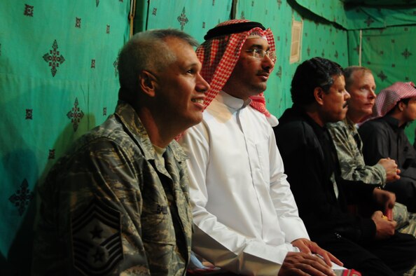 Chief Master Sgt. Mitchell Balutski, 386th Air Expeditionary Wing Command chief, spends time with locals camping outside of the base at an undisclosed location in Southwest Asia. (U.S. Air Force photo by Staff Sgt. Peter Ising)
