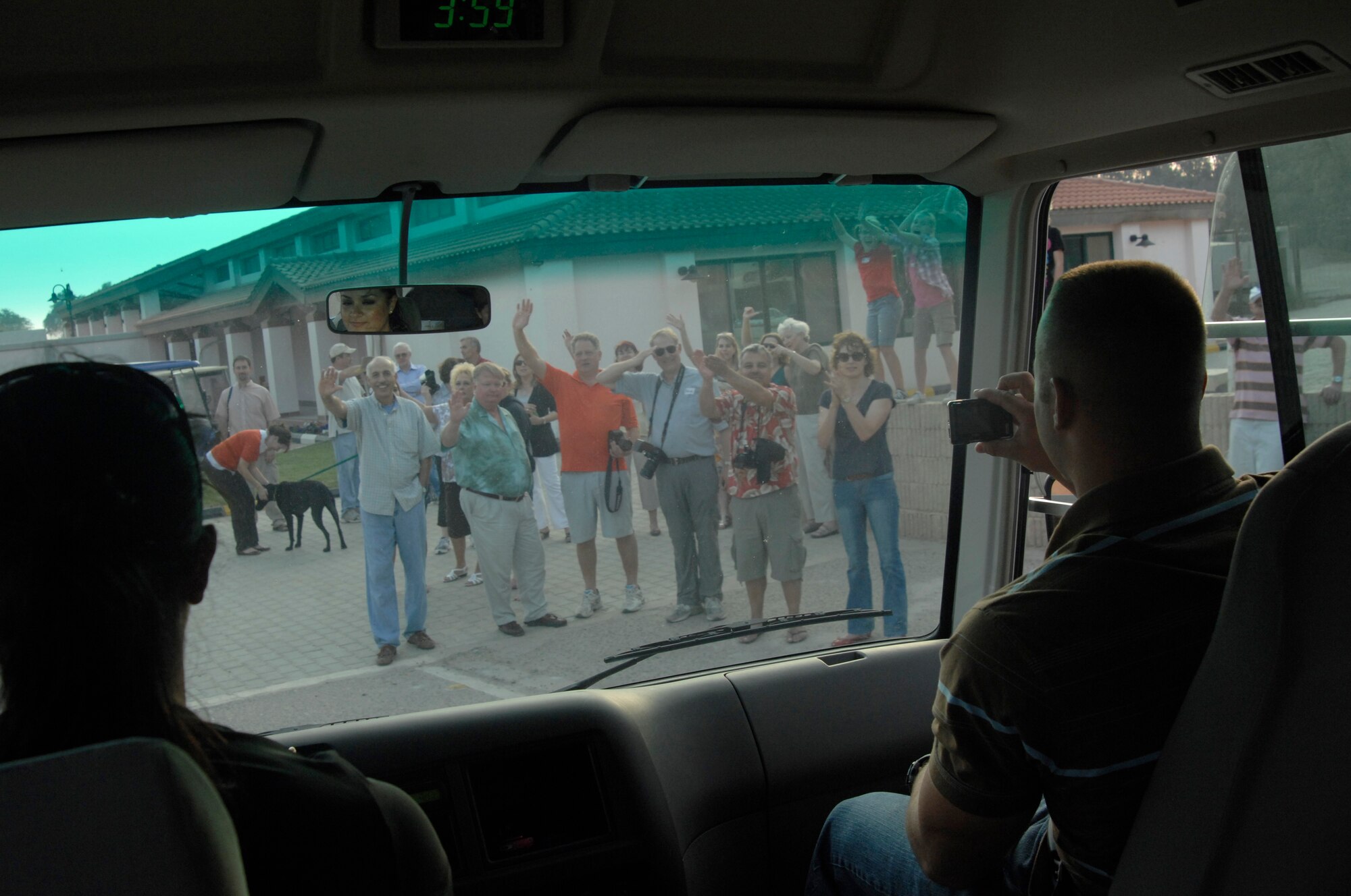Senior Airmen Vanesa Rael and Paul Heileman, both from the 332nd Expeditionary Logistics Readiness Squadron, drive past host families cheering and saluting as members of the 332nd Air Expeditionary Wing depart an undisclosed location in Southwest Asia Nov. 19, 2011. The service members were invited to a Thanksgiving celebration with other expatriates living in same country. Rael is deployed from Peterson Air Force Base, Colo., and is from Questa, N.M. Heileman is deployed from Holloman AFB, N.M., and is a native of Allendale, Mich. (U.S. Air Force photo by Senior Airman Amber R. Kelly-Herard) 

