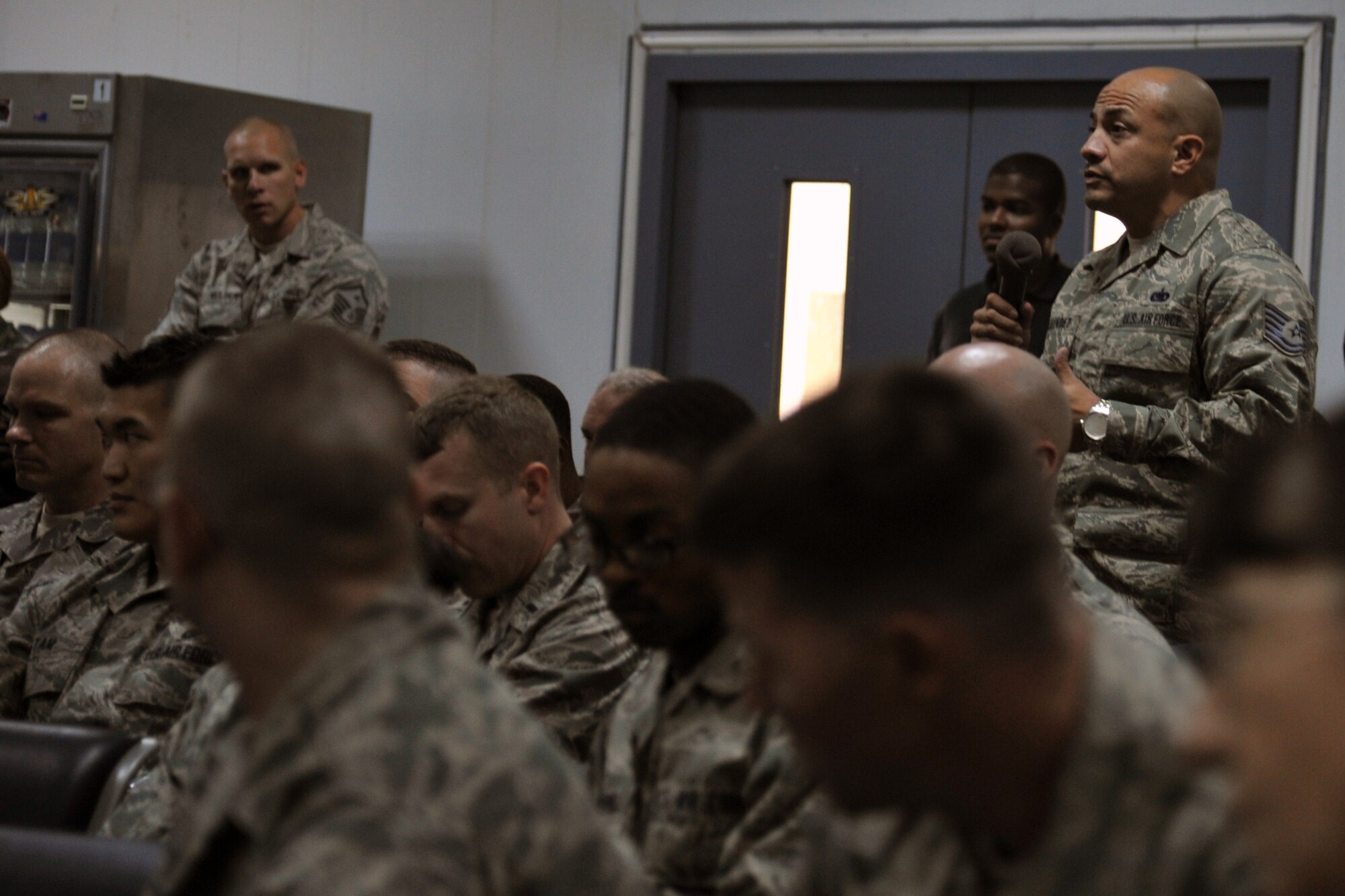Technical Sgt. Edwin Hernandez, 387th Expeditionary Support Squadron supply technician, asks Air Force Chief of Staff Gen. Norton Schwartz a question during an all call at an undisclosed location in Southwest Asia, Nov. 18, 2011. (U.S. Air Force photo by Master Sgt. Carlotta Holley)