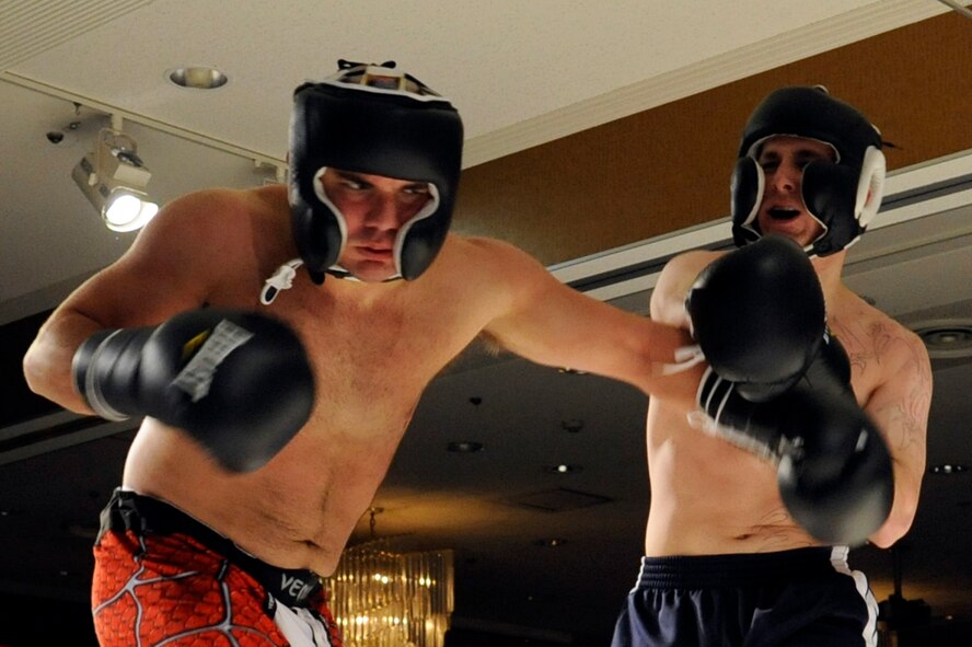 Chad Michaud, left, takes on Joshua Palmisano during 'Friday Night Fight Night' at Misawa Air Base, Japan, Nov. 18. This was the sixth fight night event held at the collocated club. The event allowed fighters to showcase their boxing skills in front of family, friends and co-workers. (U.S. Air Force photo/Tech. Sgt. Marie Brown) 
