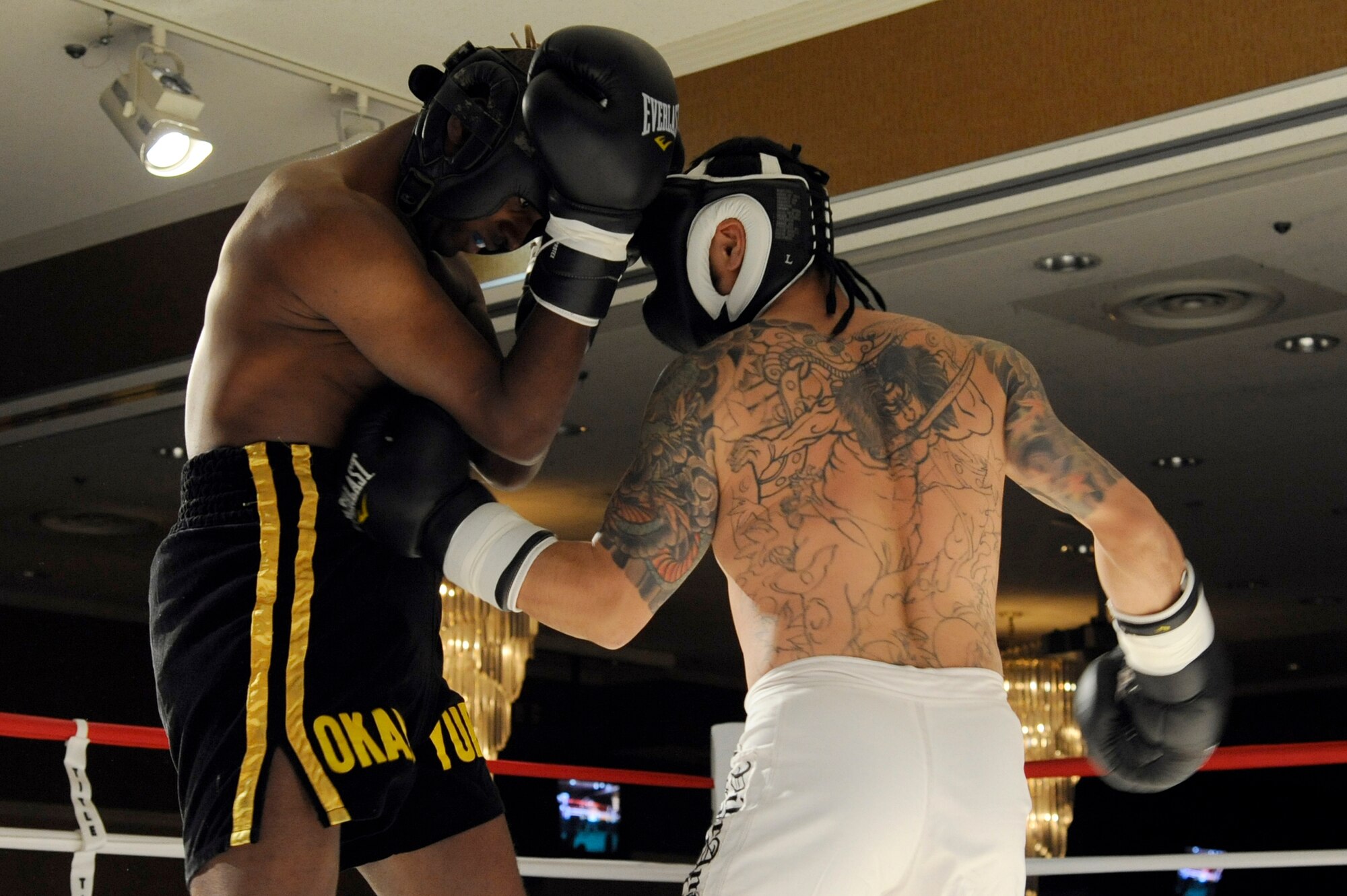 MISAWA AIR BASE, Japan - Lamont Gilkey, left, takes a few punches from Yasumori Noheji, during 'Friday Night Fight Night' here Nov. 18. This was the sixth fight night event held at the collocated club. The event allowed fighters to showcase their boxing skills in front of family, friends and co-workers. (U.S. Air Force photo/Tech. Sgt. Marie Brown)