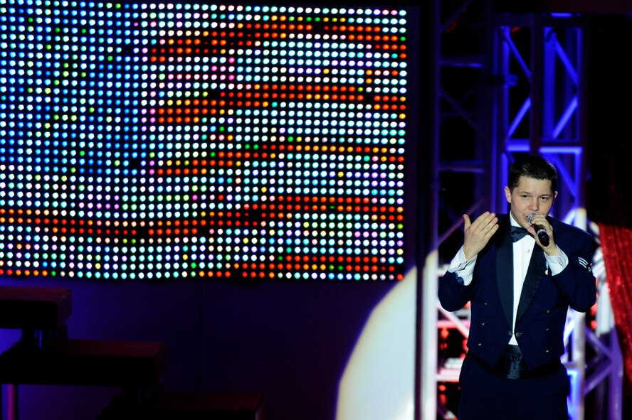 Senior Airman James Santos, a member of the Tops In Blue 2011 World Tour, sings during a performance at the Misawa Civic Center in Misawa City near Misawa Air Base, Japan, Nov. 15. The show, entitled "Rhythm Nation," brought to life the music of America, from the early 1900's through today. (U.S. Air Force photo/Tech. Sgt. Marie Brown) 

