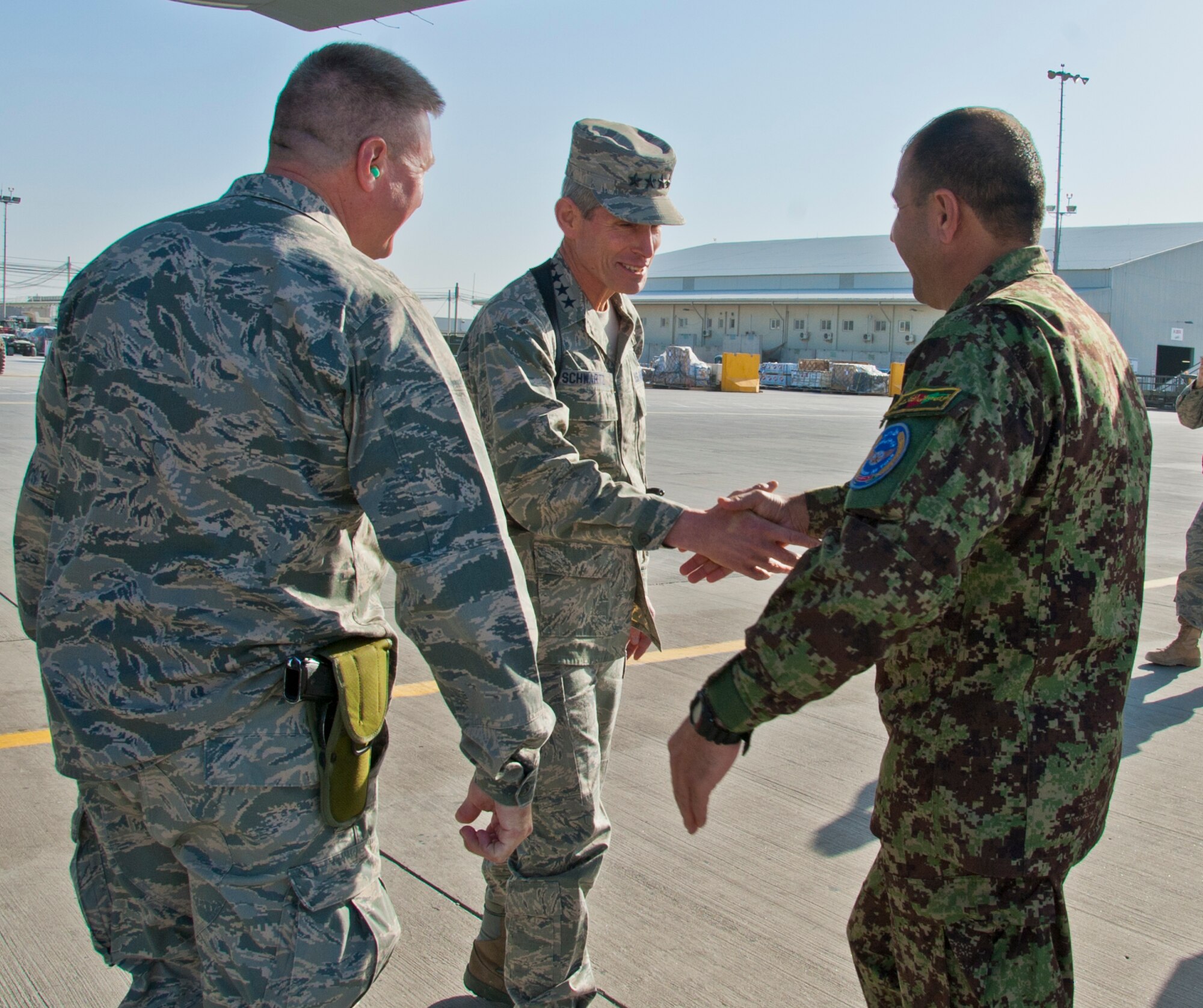 KANDAHAR AIRFIELD, Afghanistan -- Air Force Chief of Staff Gen. Norton Schwartz shakes hands with Afghan Maj. Gen. Abdul Raziq Sherzai, Afghan National Air Force, after arriving at Kandahar Airfield, Nov. 16, 2011. During his visit, Schwartz held an all call and visited with Airmen to discuss various service-wide issues. (U.S. Air Force photo/Senior Airman David Carbajal)