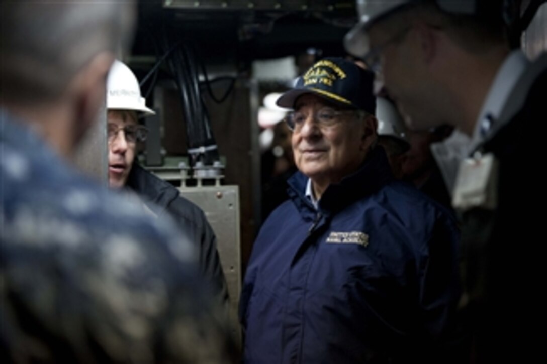 Secretary of Defense Leon E. Panetta listens to a brief from workers from General Dynamics Electric Boat aboard the USS Mississippi in Groton, Ct. on Nov. 17, 2011. 