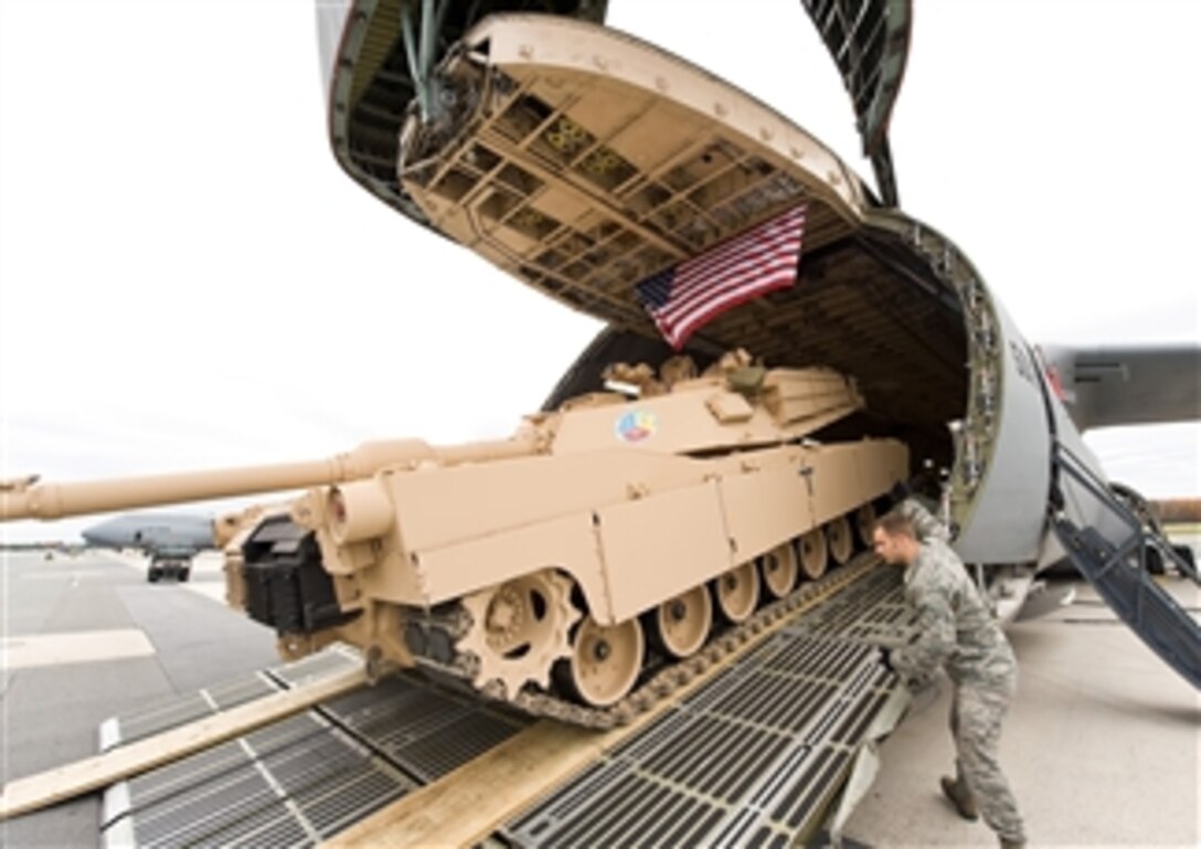 Airmen load a tank into a C-5M Super Galaxy at Dover Air Force Base, Del., on Nov. 15, 2011.  The C-5M is the upgraded version of the C-5 Galaxy.  