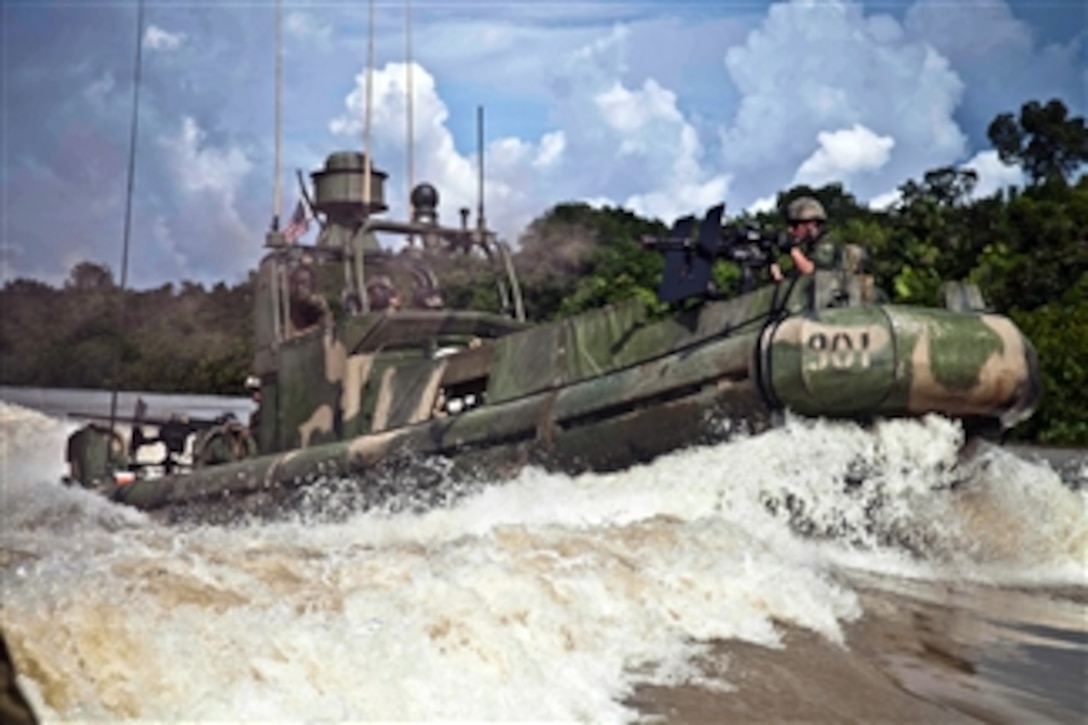 Sailors aboard a riverine patrol boat assigned to Navy Riverine Squadron 3, Detachment 1, conduct a live-fire exercise in Matuntugo, Colombia, on Nov. 11, 2011.  Riverine Squadron 3 is participating in Amphibious-Southern Partnership Station 2012, an annual deployment of U.S. military training teams to the U.S. Southern Command area of responsibility.  