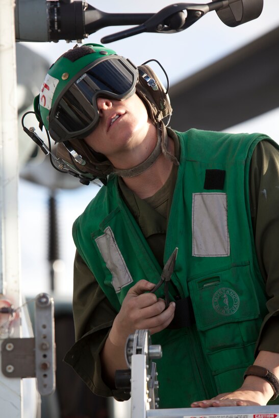 Cpl. Danielle Mckale works on a AH-1Z Super Cobra aboard USS Makin ISland here Nov. 18. Mckale is an aviation technician with Marine Medium Helicopter Squadron 268 (Reinforced). The squadron is the aviation combat element with the 11th Marine Expeditionary Unit, which embarked USS Makin Island, USS New Orleans and USS Pearl Harbor in San Diego Nov. 14 beginning a seven-month deployment to the Western Pacific and Middle East regions.