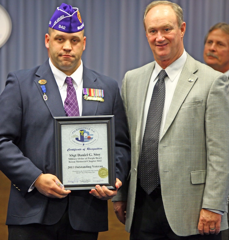 Staff Sgt. Daniel G. Stoy, a Hudson Falls, N.Y. native and infantry unit leader with 8th Marine Regiment, 2nd Marine Division, is presented the City of Jacksonville, North Carolina’s Outstanding Veterans Award from the city mayor during an awards ceremony at the city’s town hall Nov. 22. He was recognized for his outstanding work in the community and is a member of the Military Order of the Purple Heart.