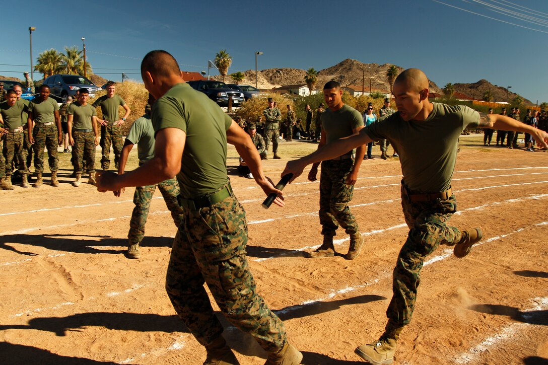 Marines with Marine Corps Communication-Electronics Schoo, pass off a baton during the all-hands relay race around the track at Felix Field during the battalion’s Olympiad and Family Day events at Felix Field Nov. 22, 2011.