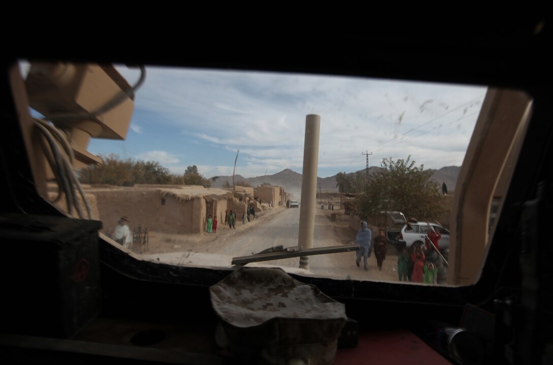 Little more than two months ago, the region through which Route 611 traced north through Helmand province was a dangerous one, at best, and saw little commercial activity. As seen through the windshield of a "7-ton" Medium Tactical Vehicle Replacement truck, Nov. 22, near-ghost towns are teeming with life once again as a result of Operation Eastern Storm. The major offensive, led by the 1st Battalion, 6th Marine Regiment, aimed to drive the Taliban-led insurgency from the region, while also reestablishing a sense of order among the local populace. (U.S. Marine Corps photo by Sgt. Justin J. Shemanski)