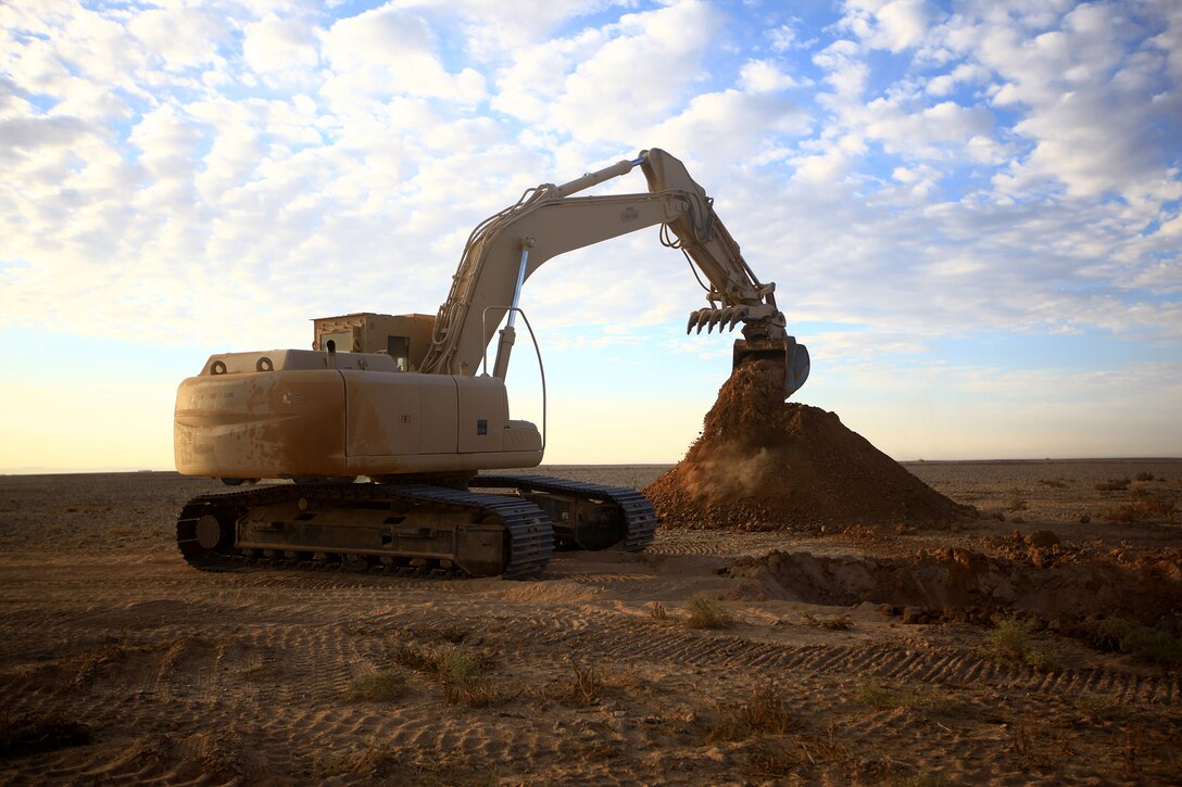 A construction vehicle belonging to 9th Engineer Support Battalion, 2nd Marine Logistics Group (Forward), moves dirt as part of a road building mission in Helmand province, Afghanistan, in late 2011. The road will be a main supply route for coalition forces and local Afghans in the Shir Ghazay area. (U.S. Marine Corps photo by Cpl. Katherine M. Solano)
