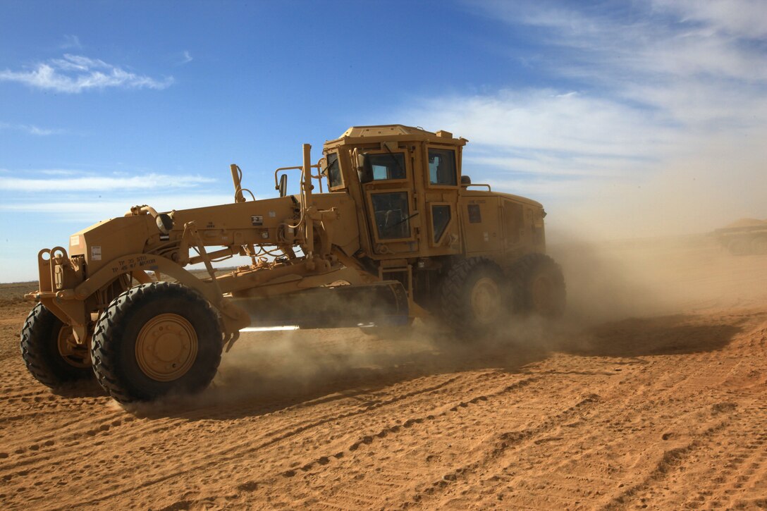 A construction vehicle belonging to 9th Engineer Support Battalion, 2nd Marine Logistics Group (Forward), drives along a construction site in Helmand province, Afghanistan, in late 2011. The Marines with 9th ESB are building a route in the Shir Ghazay area to provide a safe way to travel for local Afghans and coalition forces. (U.S. Marine Corps photo by Cpl. Katherine M. Solano)