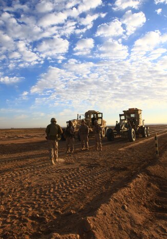 Sgt. Bunnarath Gnoy (second from left), the heavy equipment chief with Alpha Company, Combat Logistics Battalion 1, 2nd Marine Logistics Group (Forward), stands among other engineers with his unit at a worksite in Helmand province, Afghanistan, Nov. 23. Gnoy says that his leadership style in the Marine Corps will carry over into parenting his newborn son as he grows older. (U.S. Marine Corps photo by Cpl. Katherine M. Solano)