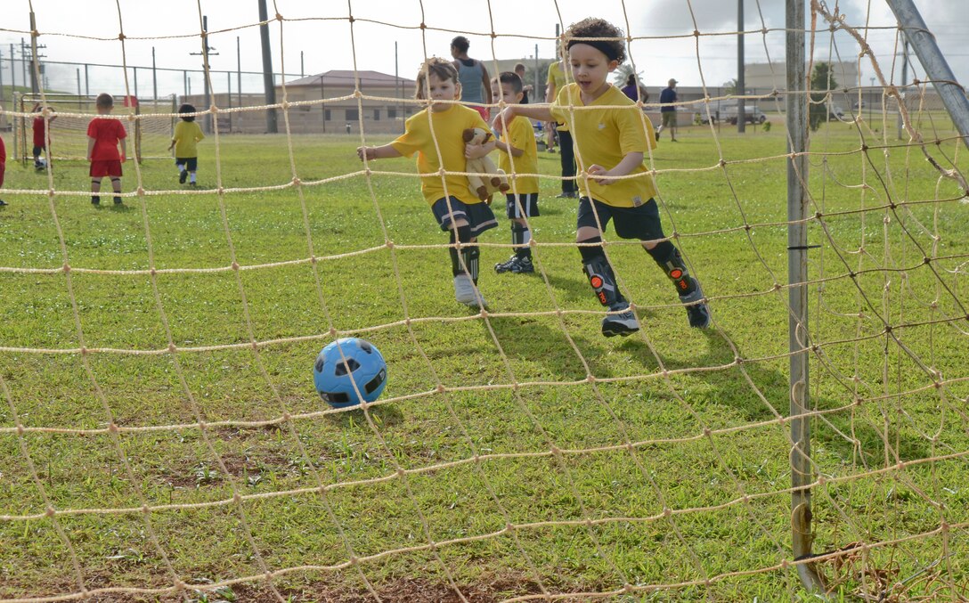 ANDERSEN AIR FORCE BASE, Guam -- Children ages 3-5 play in a soccer game
Nov. 20 here as part of the new 'Sports for Tots' program. The soccer season
began Nov. 8 and will last six-week sessions giving parents time to sign their children up. The next season sport will be baseball then football and cheerleading. There will be roughly a two week break between each season. For more information, e-mail Mrs. Rhine at sportsfortotsaaf@yahoo.com or visit the Sports for Tots Facebook page using the same e-mail address.  (U.S. Air Force photo/Staff Sgt. Alexandre Montes)
