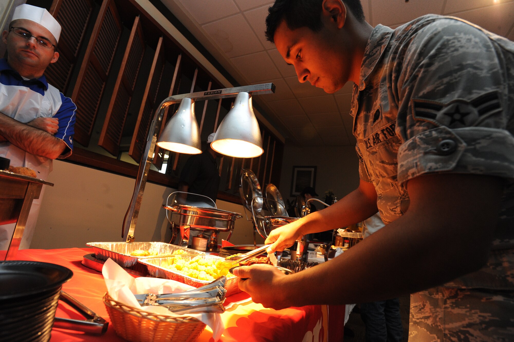 Airman 1st Class Jorge Nevarez, 22nd Force Support Squadron storeroom specialist, samples tater tots during a food show at the Chisholm Trail Inn Dining Facility Nov.  22, 2011, McConnell Air Force Base, Kan.  The food show is held quarterly to introduce new menu items at the dining facility that will be available to Airmen. (U.S. Air Force photo/ Airman 1st Class Jose L. Leon)