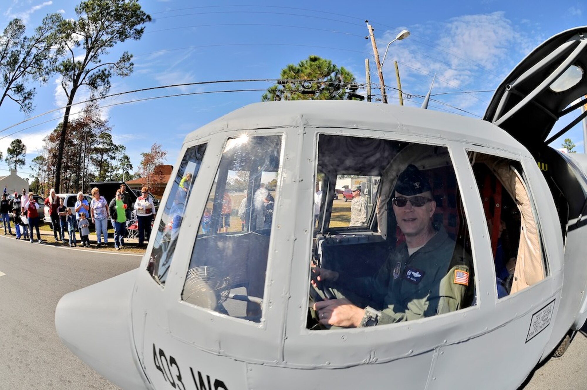 Lil Bill, the 403rd Wing's miniature C-130 aircraft, appeared at the Veteran's Day Parade in D'Iberville, Miss. Col. Jay Jensen, the Commander of the 403rd Wing, drove Lil Bill around the parade route. He's logged many flying hours in a C-130, but never at this altitude, he admits (U.S. Air Force Photo by. Capt. J. Justin Pearce) 