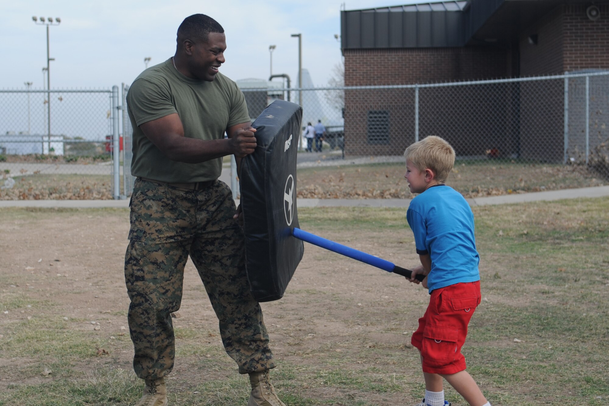 GOODFELLOW AIR FORCE, Texas -- Aiden Roschi spars with Marine Staff Sgt. Adam Slaughter, Marine Corps Detachment, during Community Appreciation Day Nov. 19. Roschi is the son of Air Force Staff Sgt. Lynn Roschi, 316th Training Squadron Instructor. (U.S. Air Force photo/Staff Sgt. Laura R. McFarlane)
