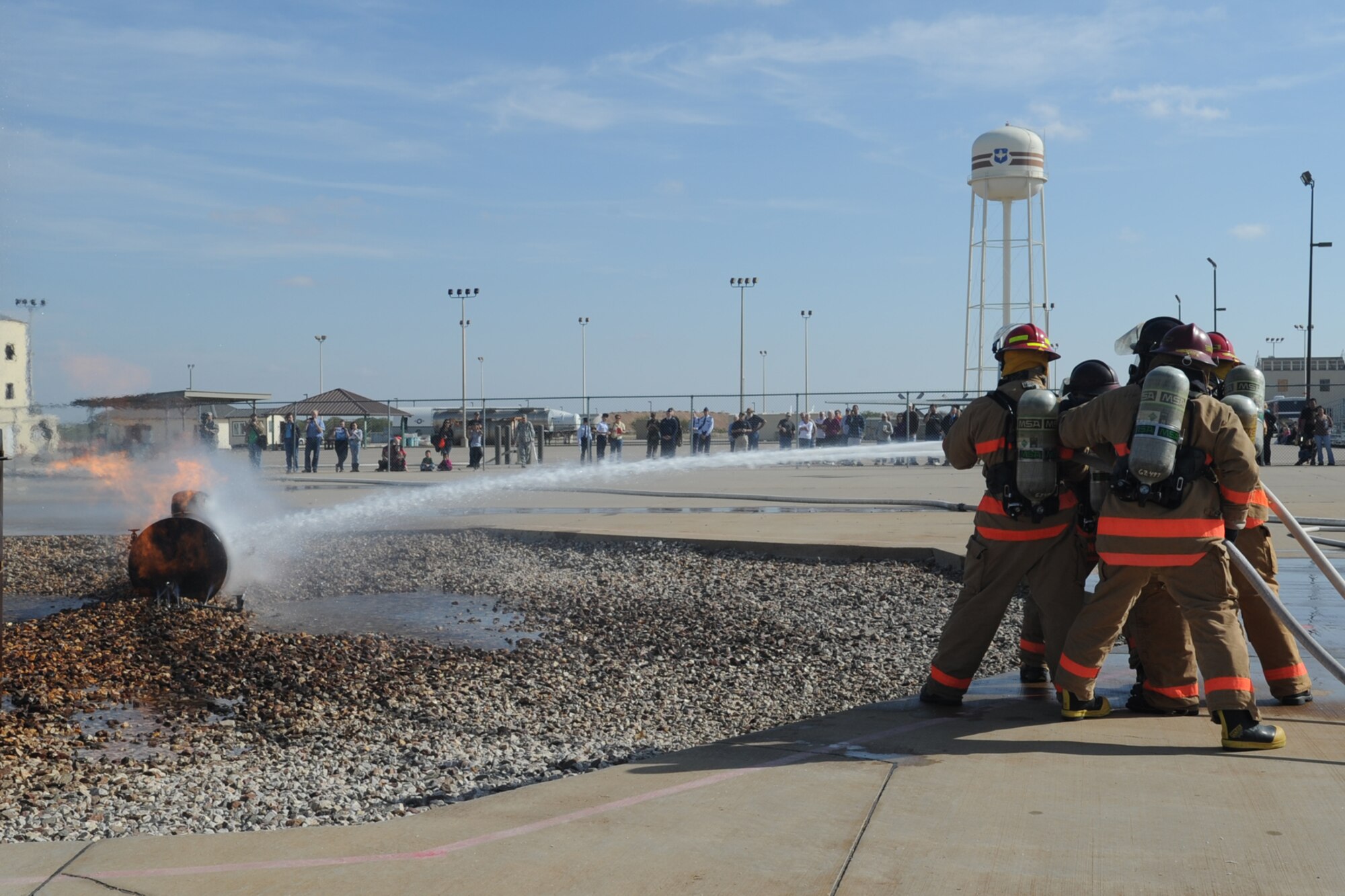 GOODFELLOW AIR FORCE BASE, Texas -- Instructors from the 312th Training Squadron Louis F. Garland Department of Defense Fire Academy, demonstrate aircraft firefighting techniques for members of the San Angelo community during Community Appreciation Day Nov. 19. More than 2200 students from all branches of the DOD attend the apprentice and advance courses annually. (U.S. Air Force photo/Staff Sgt. Laura R. McFarlane)