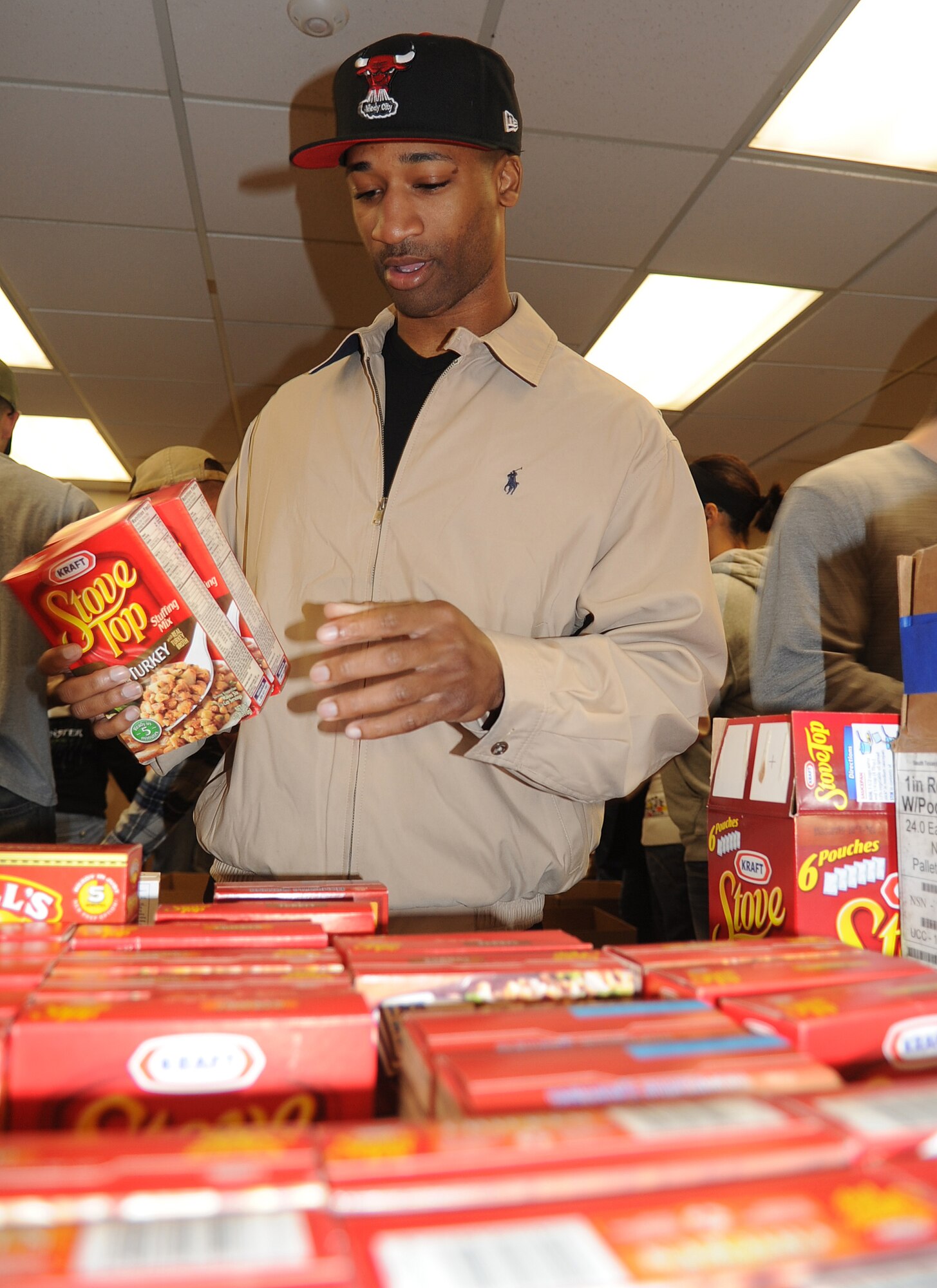 Staff Sgt. Patrick Willis, 4th Communications Squadron client support technician, organizes donated stuffing during the annual Thanksgiving food drive at Seymour Johnson Air Force Base, N.C., Nov. 19, 2011. The Airman Leadership School donated their time to build boxes to be distributed to Airmen and their families in need of assistance during the holiday. Willis hails from Chesapeake, Va. (U.S. Air Force photo by Senior Airman Gino Reyes)