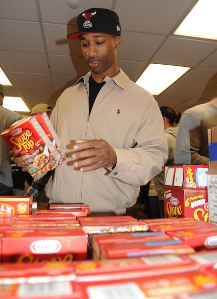 Staff Sgt. Patrick Willis, 4th Communications Squadron client support technician, organizes donated stuffing during the annual Thanksgiving food drive at Seymour Johnson Air Force Base, N.C., Nov. 19, 2011. The Airman Leadership School donated their time to build boxes to be distributed to Airmen and their families in need of assistance during the holiday. Willis hails from Chesapeake, Va. (U.S. Air Force photo by Senior Airman Gino Reyes)